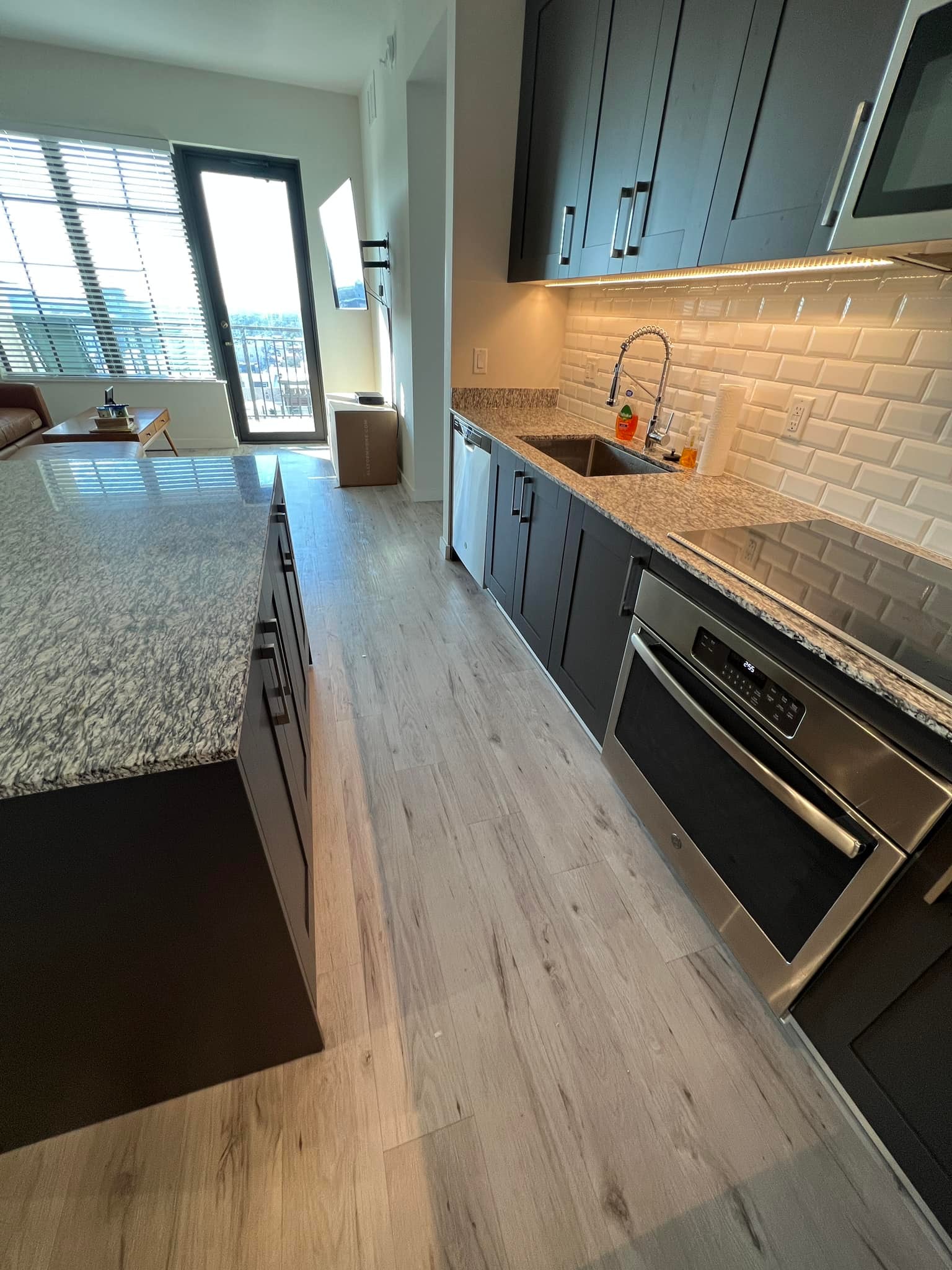 Open concept living and kitchen environment maintained through recurring home care and ongoing environmental support