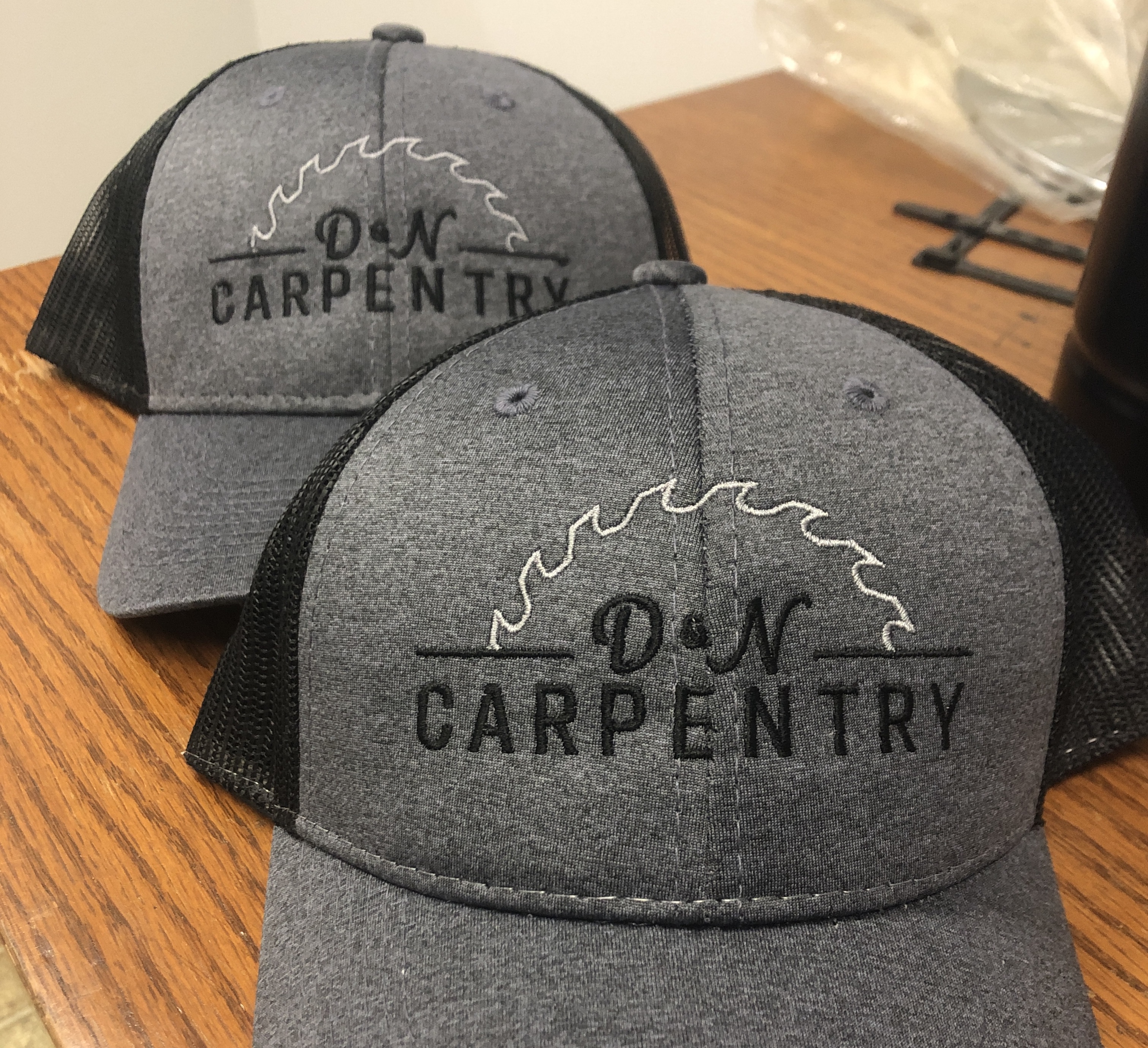 Two embroidered hats with customer logo