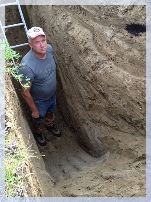A man standing in a hole in the ground