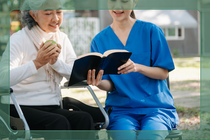 A young caregiver and an elderly woman looking at a book together A young caregiver and an elderly woman looking at a book together