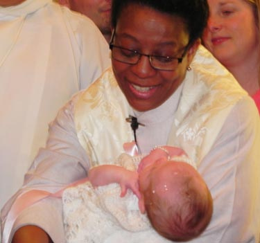 Hilary Murray baptizes a new member