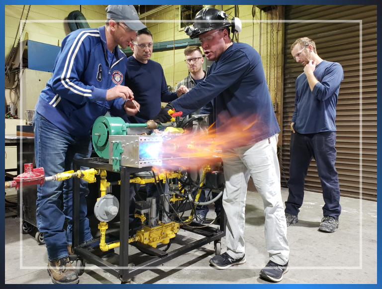 Five men getting trained on a machine