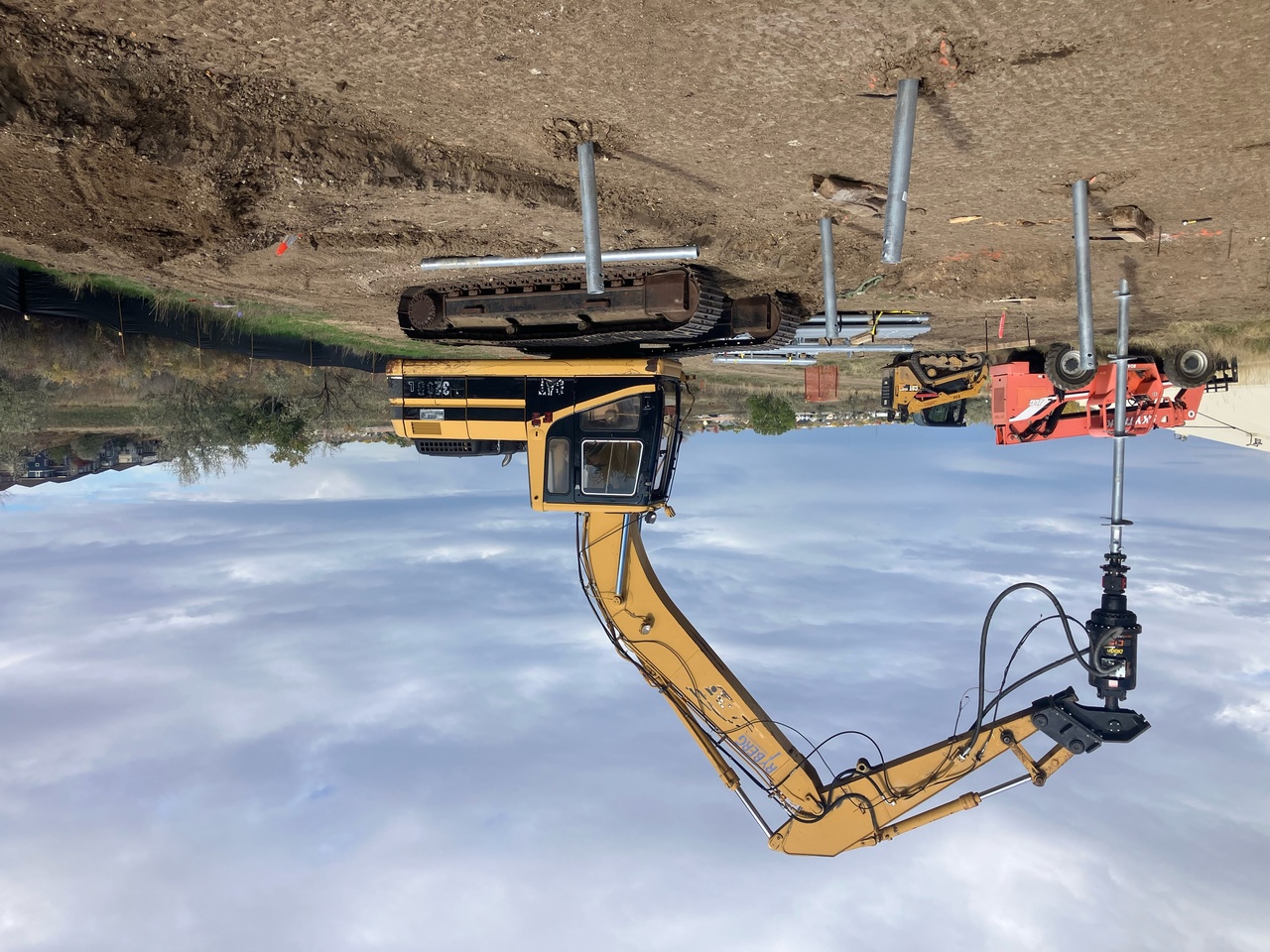 Installing Piers with Cat Excavator