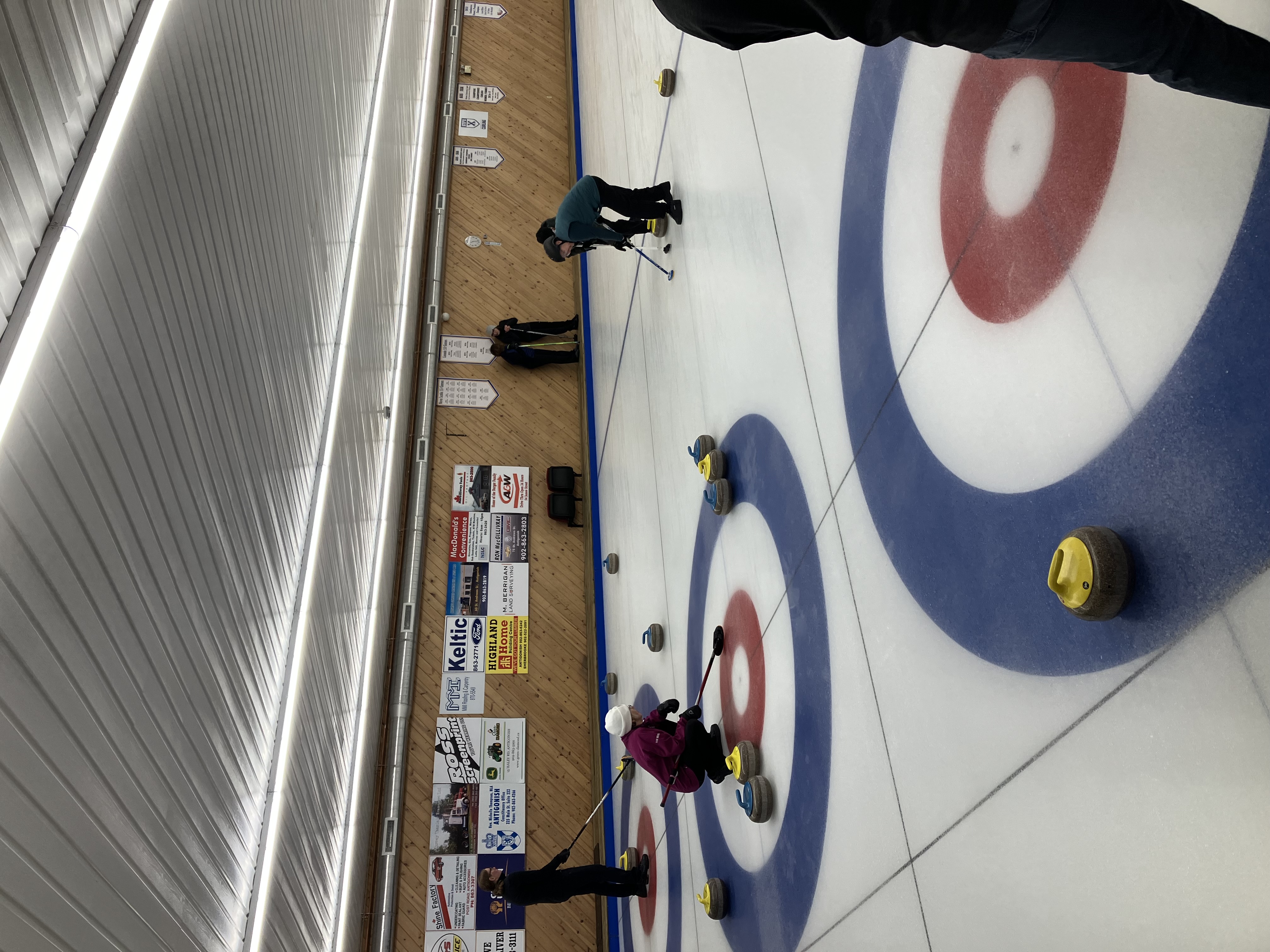 Joyce VanBurkel calling line while Roselle and Roy Lawlor sweep