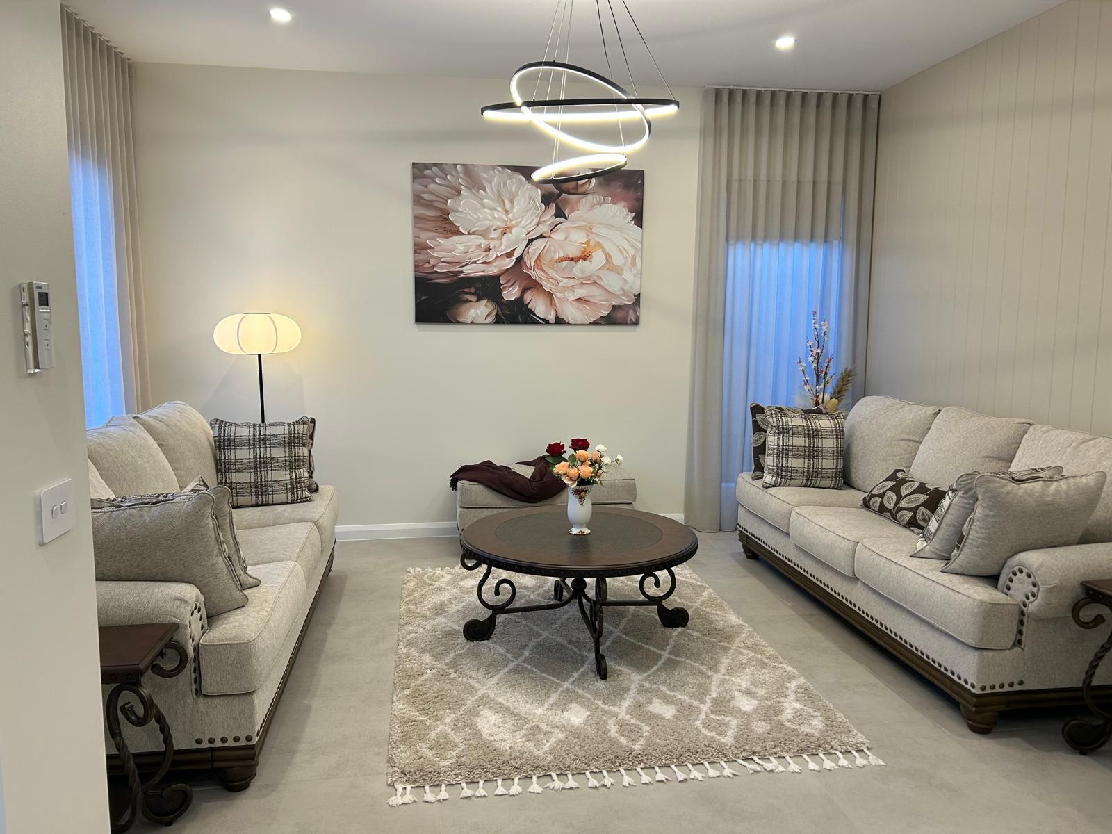 Person selecting fabric swatches and tile samples over architectural plans on a desk with a laptop. Person selecting fabric swatches and tile samples over architectural plans on a desk with a laptop.