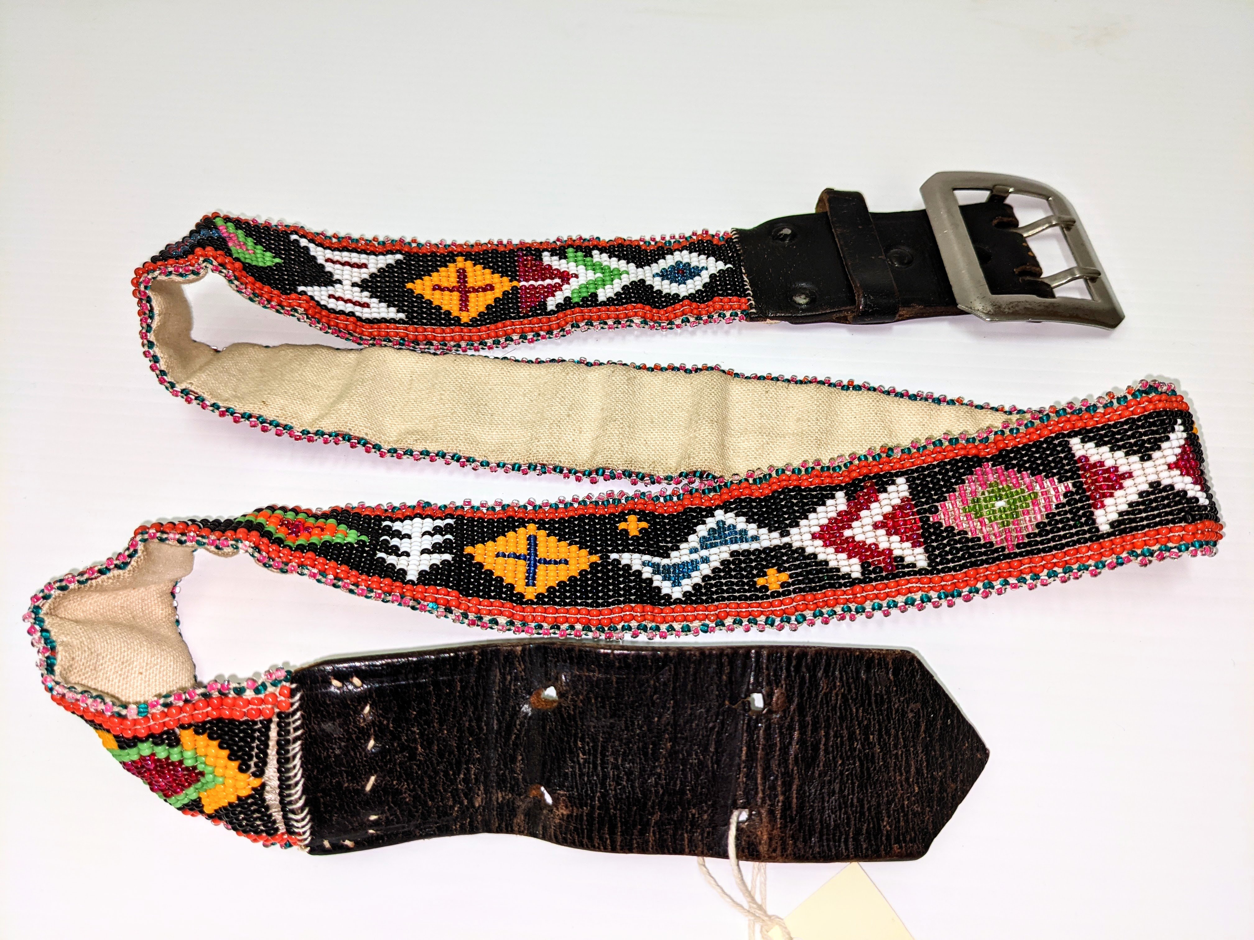  Although we do not have information on the artisan or the age of this beautiful artifact, the composition of the piece make it very interesting. First you will notice the incredibly uniform and intricate beadwork - typical of many indigenous artists. Upon further inspection you can see that the belt itself is not made of leather but rather canvas. This was likely done for ease of beading - though it is possible that the artist recycled a broken belt using the hardware and leather of either end. Recycling and reusing everything from building materials, to beads has long been practiced in Fort Vermilion and is part of what has allowed the settlement to prosper since 1788!

24/05/2021
2005.44.08 / Randolph, Helen