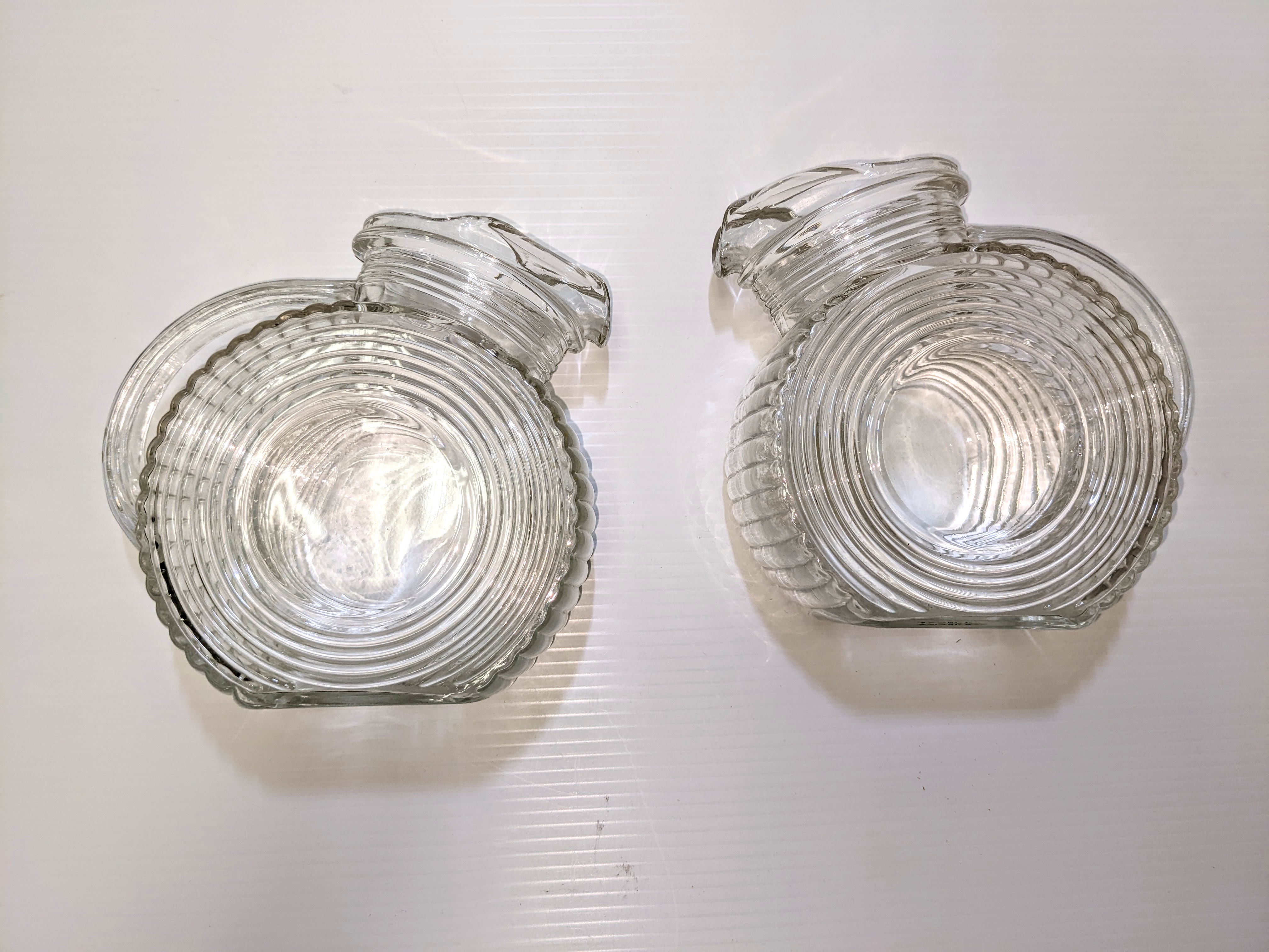 These two water pitchers were hard earned by Rachel (Boire) Erhman. She won them as an 11 year old in a spot dancing competition in 1938 at the Diamond P Hall. Spot Dancing requires one to dance within a boundary despite the music becoming faster and the boundry smaller. The Diamond P hall was located close to where the school Division office currently rests and was an important social gathering space for the community. The west hill leaving Fort Vermilion is historically known as Diamond P Hill -Diamond P being the slang name for the Peace River Trading Company which was operated in Fort Vermilion by Fred Lawrence.
2010.95.04+05 / Erhamn, Rachel (Boire) 13/09/2022
