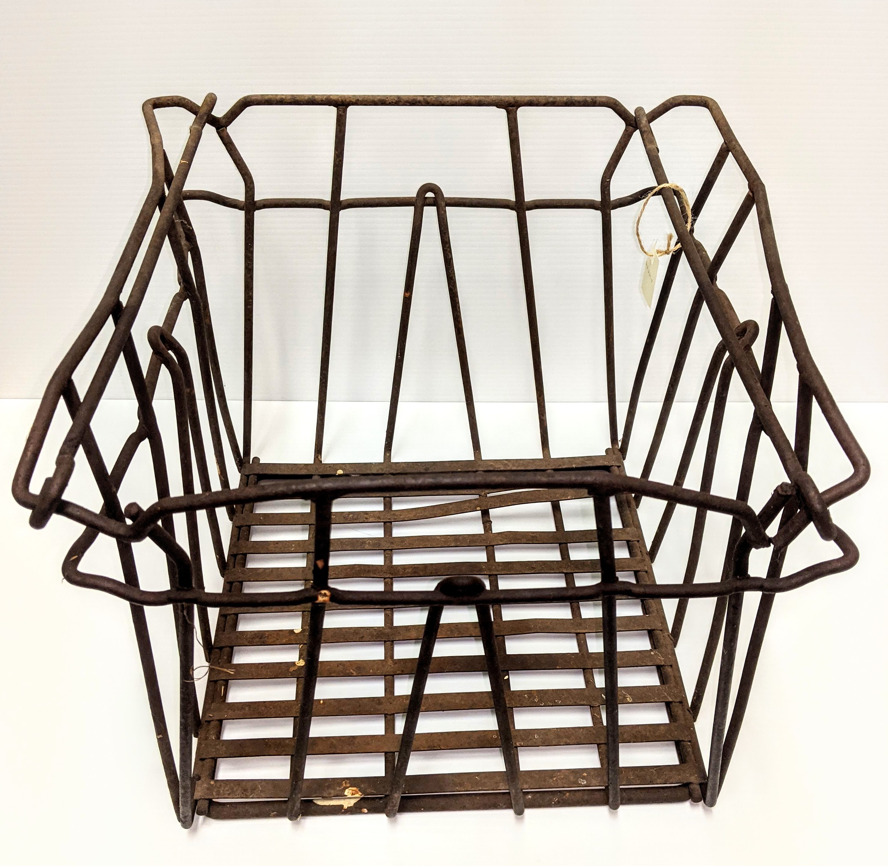 This is a vintage milk crate. The use of milk crates dates back to late 1800's but it wasn't until after WWII that crates made out of heavy gauge steel wire (such as this one) were designed. The crate made distributing and collecting milk bottles much more efficient - but not necessarily easier. This crate weighs 10lbs empty and when filled with full milk bottles would be well over 30lbs. The Newman and Lett families had a milk / cream route through Fort Vermilion for a number of years in the 40's with deliveries all across town.
2002.234.04 / Stanley-Turner, Glean & Laurene
