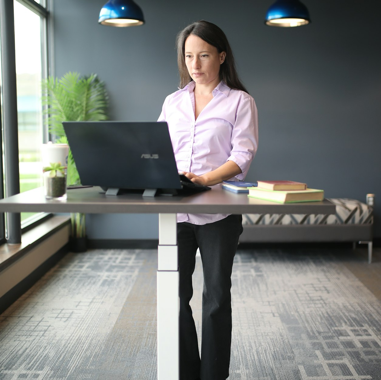 Businessman holding tablet in modern office, smiling confidently.