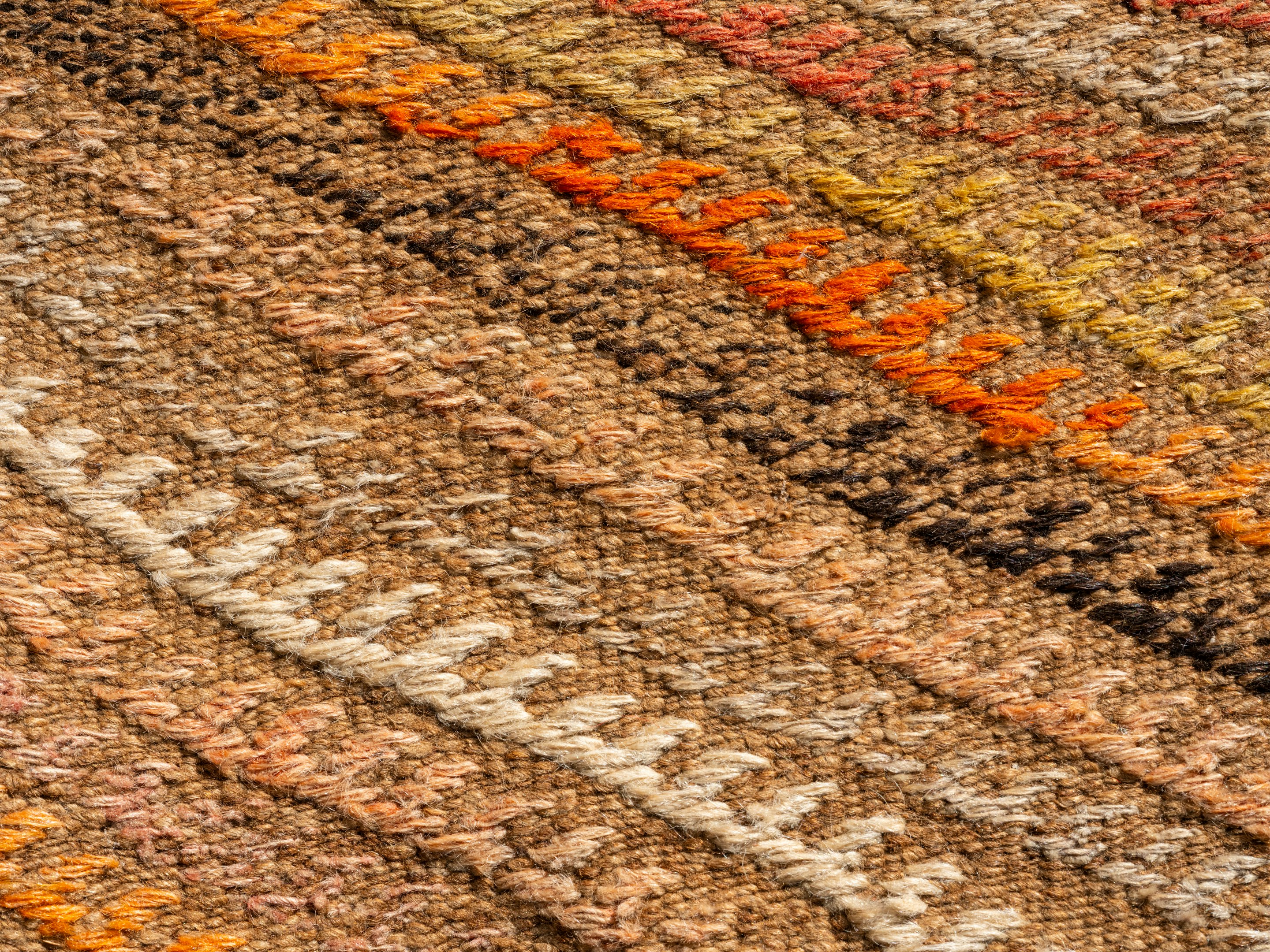 A close up of a multi colored rug A close up of a multi colored rug