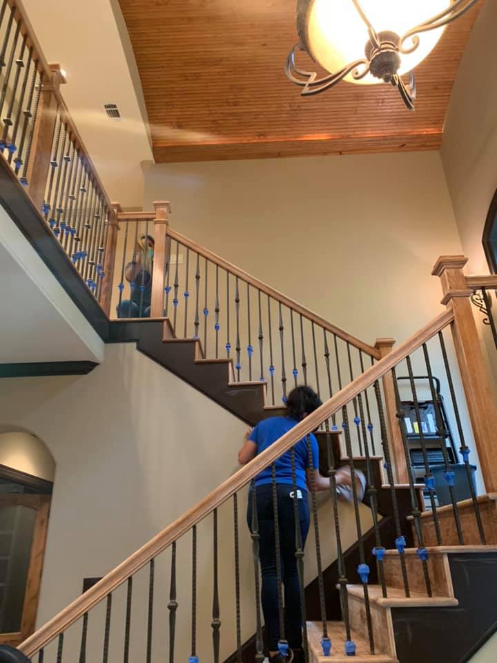 cleaners cleaning banister 