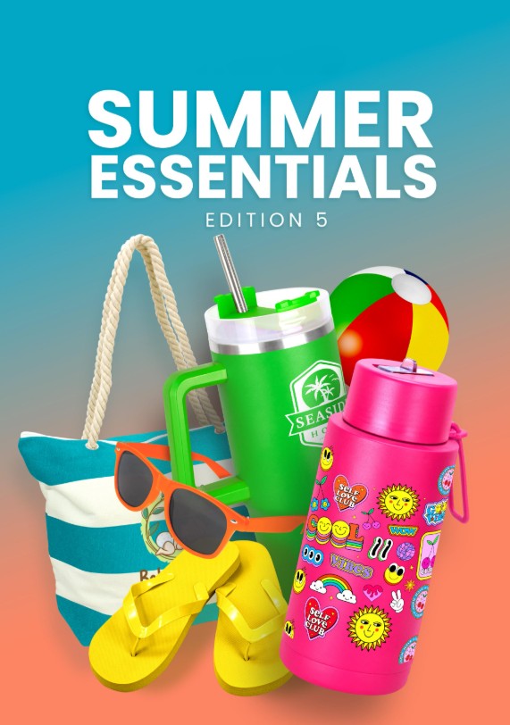 Cup of fresh strawberries and small fruits on a wooden table with dessert plates and a glass of juice.