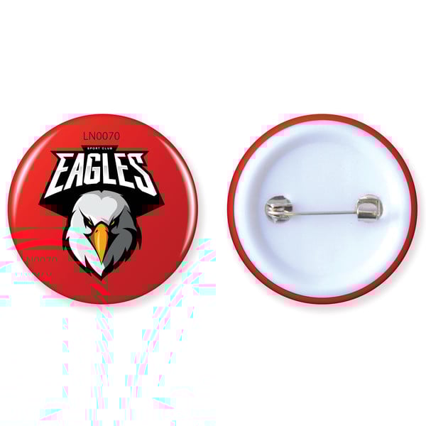 Smiling barista wearing an apron and gloves standing behind a coffee counter in a cafe setting with shelves full of bottles in the background.