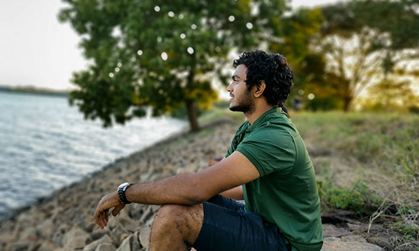 Man Sitting on Rock