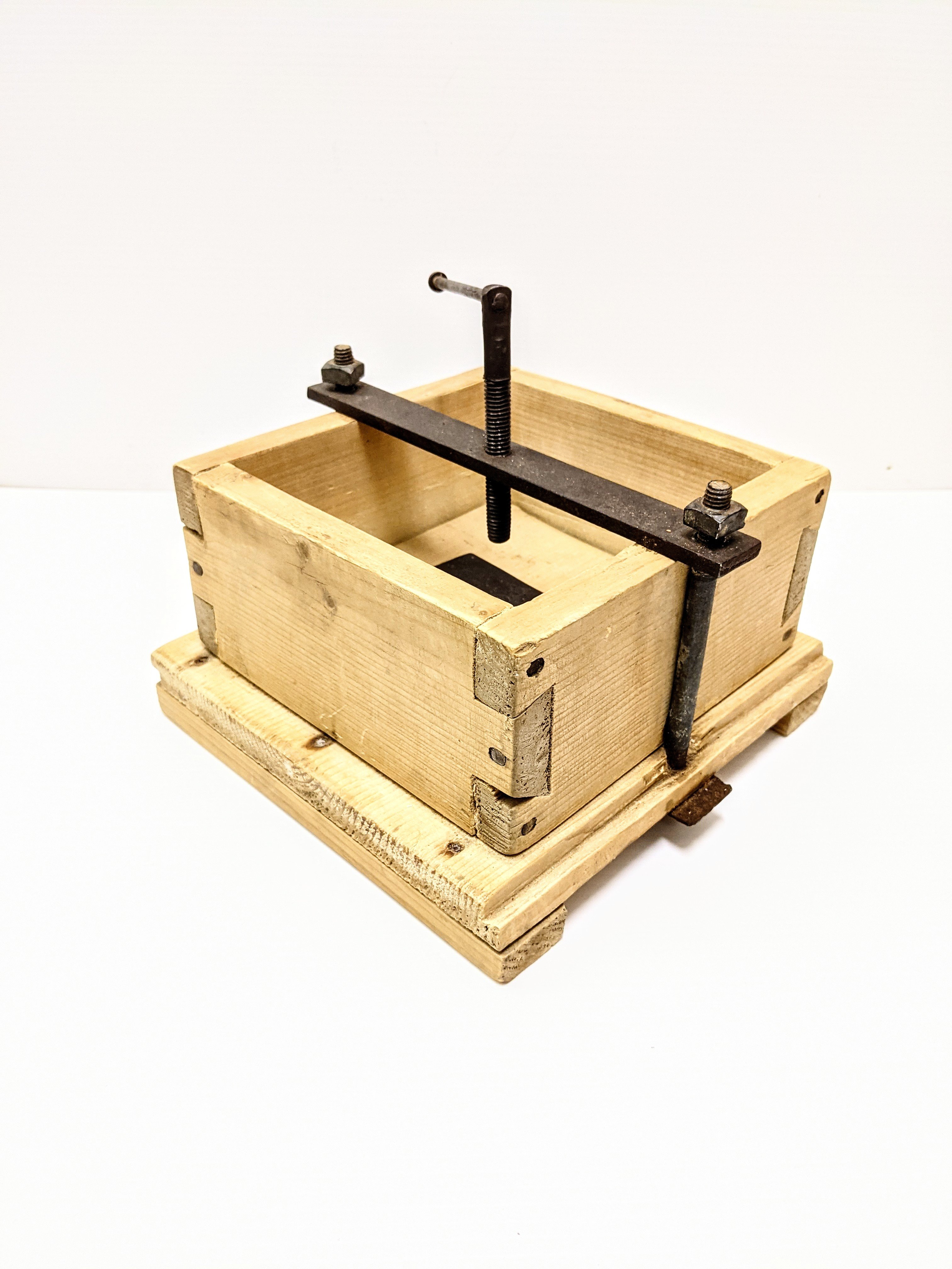 This artifact of the week is a food press from the Trapper Shack. A homemade affair, this large block likely was used to press cheese or butter. Upon close inspection one can see the remains of such food products pressed into the wood base and sides. Holes are drilled in the base to allow for drainage of the inserted food item. Notice the expertly carved dove tail notching holding the box together - an important feature for this box that would be under pressure/ stress for extended periods of time!
10/05/2021
2007.47.11.1 / Trapper Shack