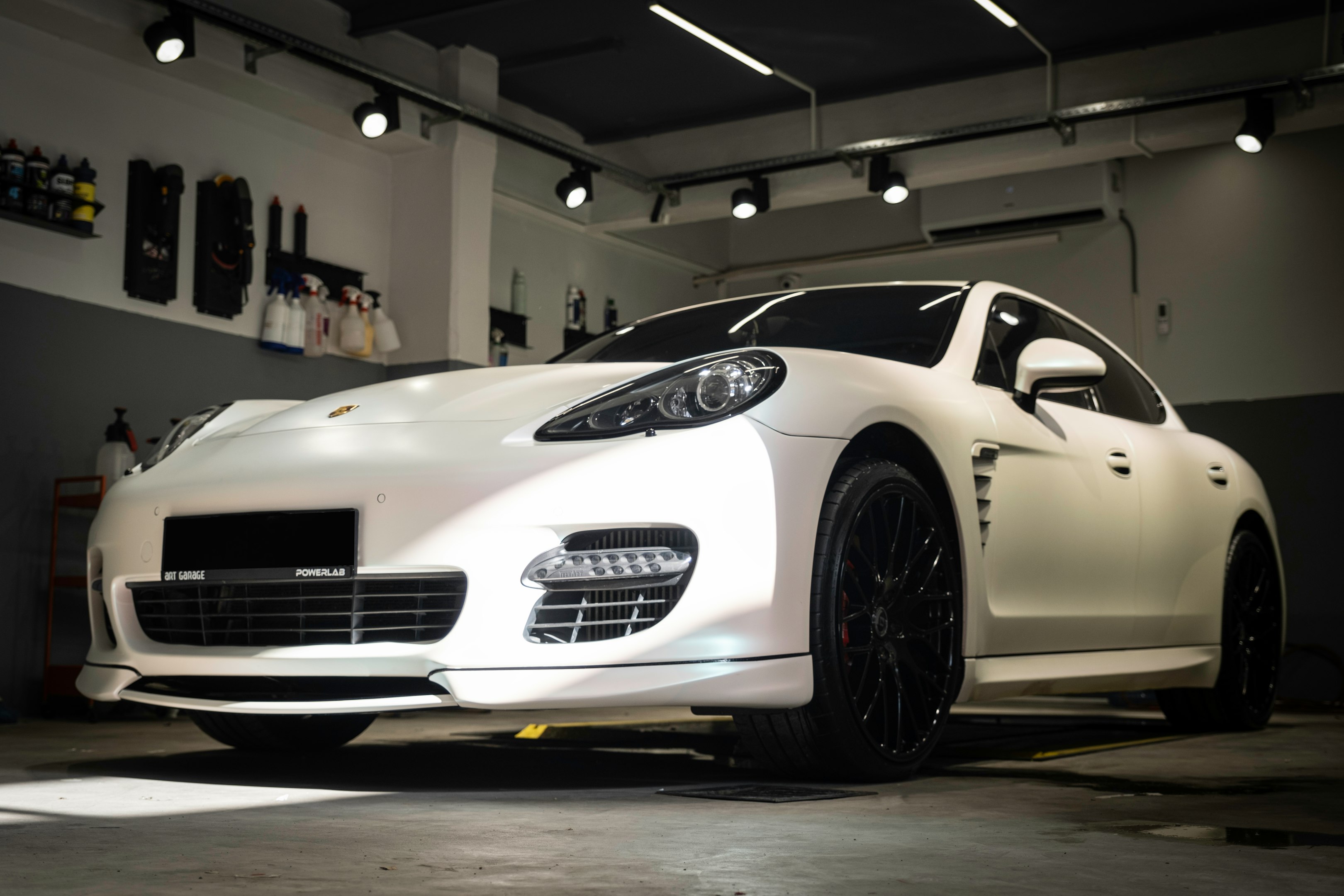 a white sports car parked in a garage