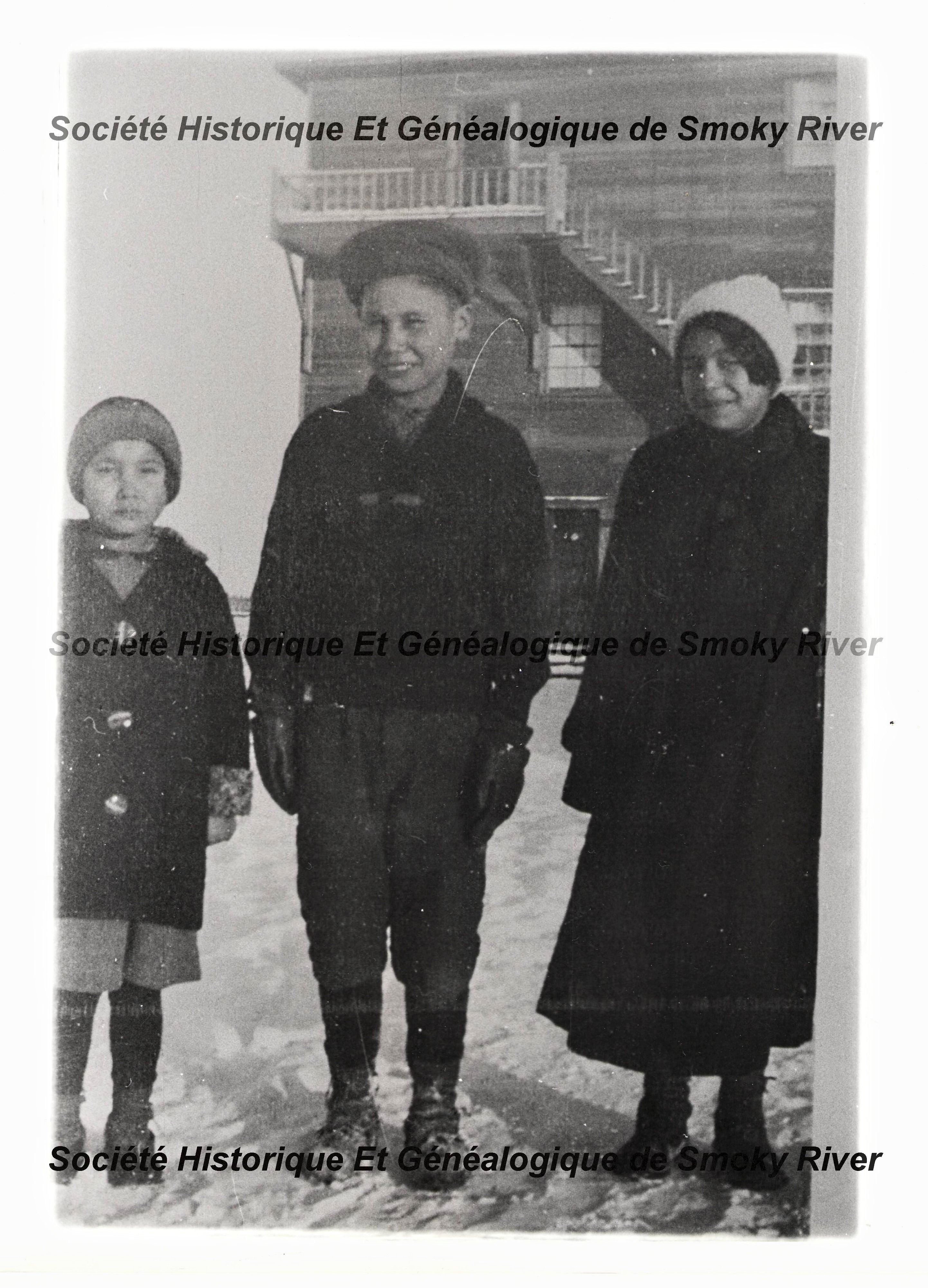 These three are labelled as "The Moberly's" but their first names are unknown. They stand on the west end of what appears to be the third Catholic convent - which would date the photo as late 30's / early 40's. Please let us know if you recognize them!
2006.01.367 / Societe Historique et Genealogique de Smoky River