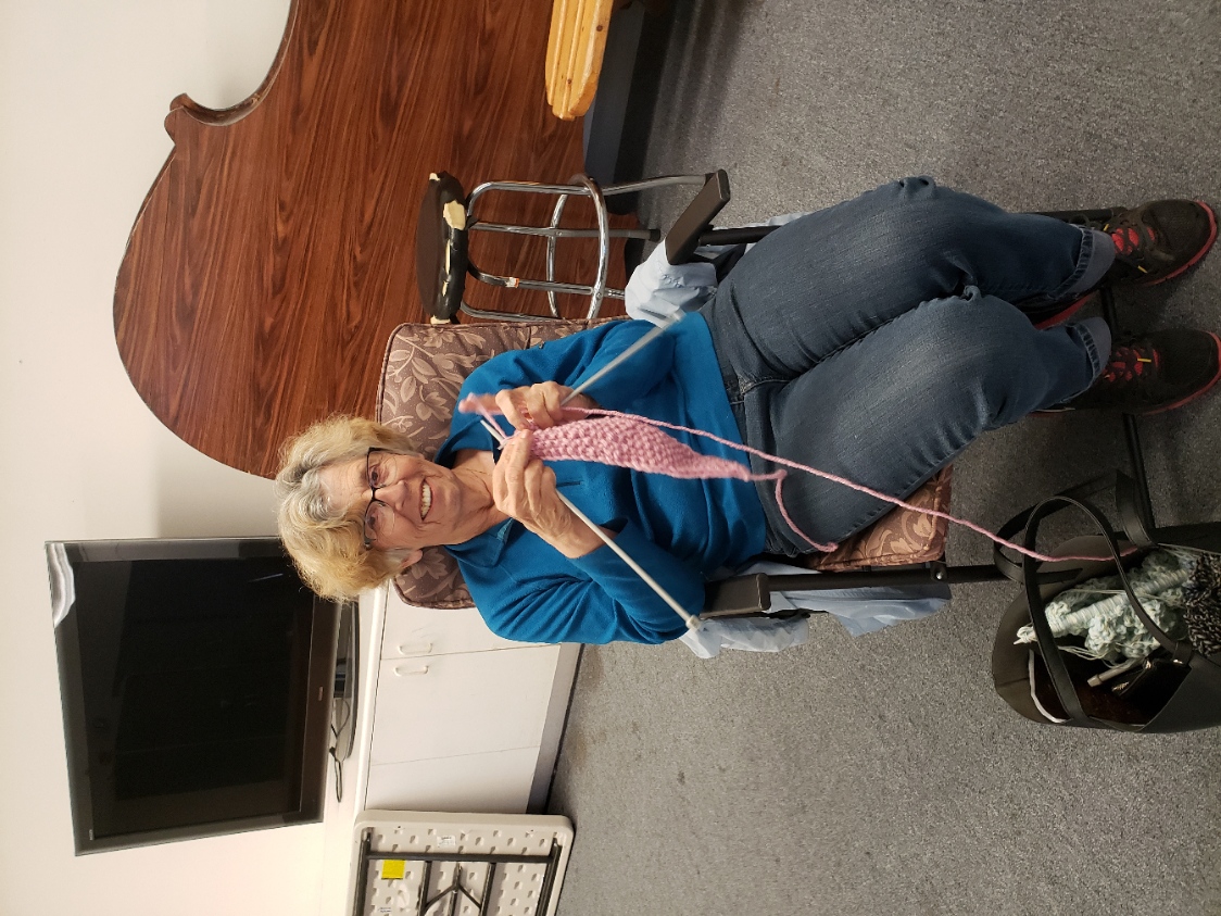 Rita social distancing while knitting a head band.