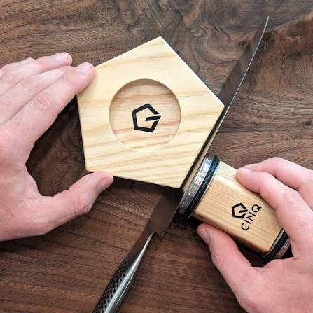 Hands mixing eggs and flour in a glass bowl, surrounded by whole eggs and raisins on a wooden table. Hands mixing eggs and flour in a glass bowl, surrounded by whole eggs and raisins on a wooden table.