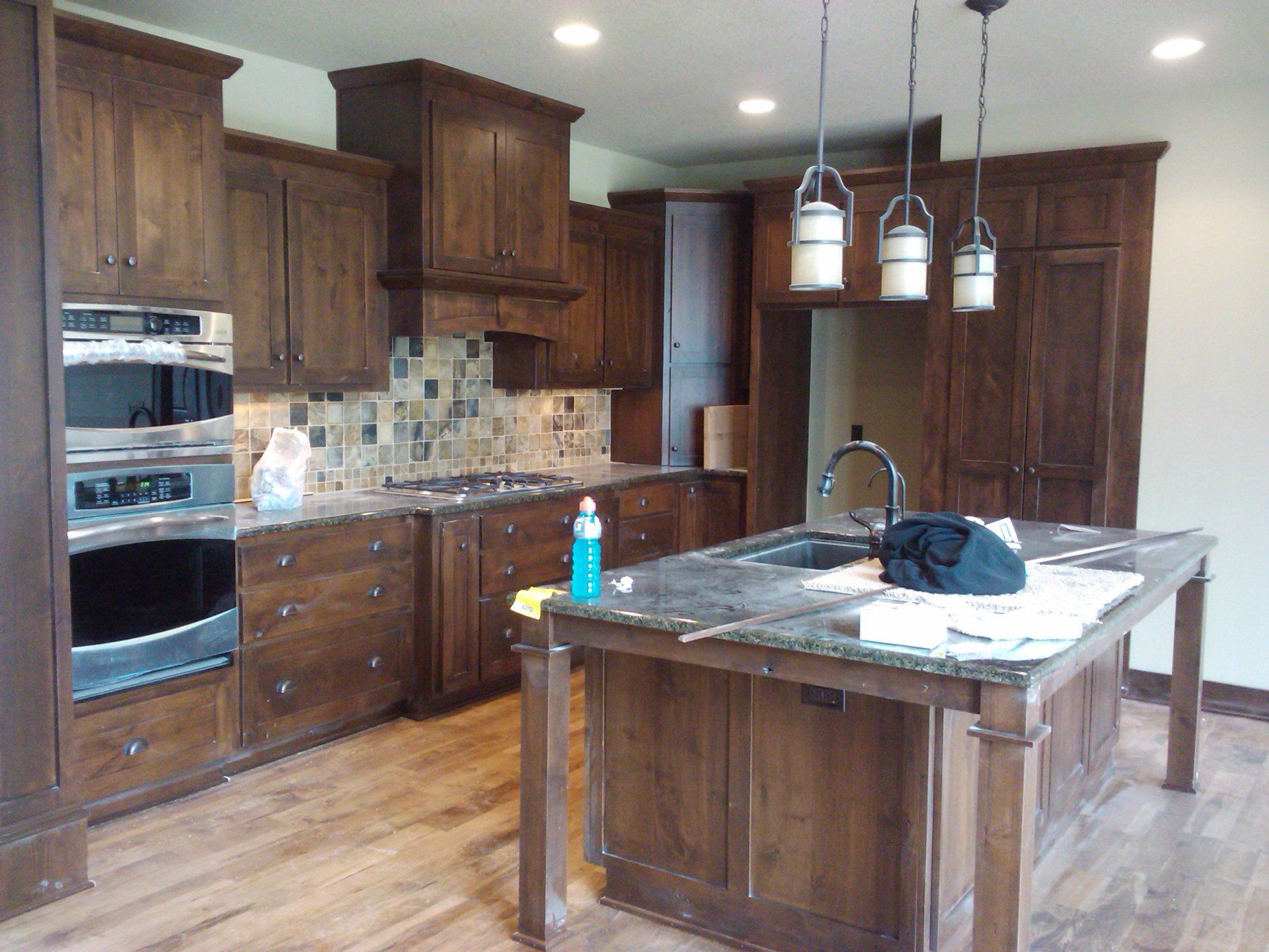 Luxury residential kitchen in active post-renovation condition with residual project materials and surfaces awaiting recovery preparation