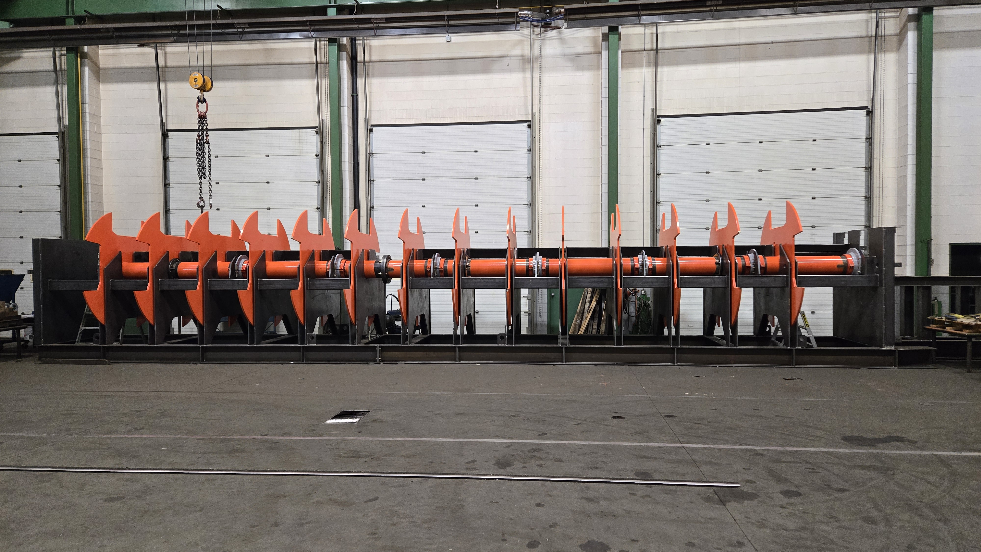 Industrial laser cutting machine emitting sparks in a factory setting.