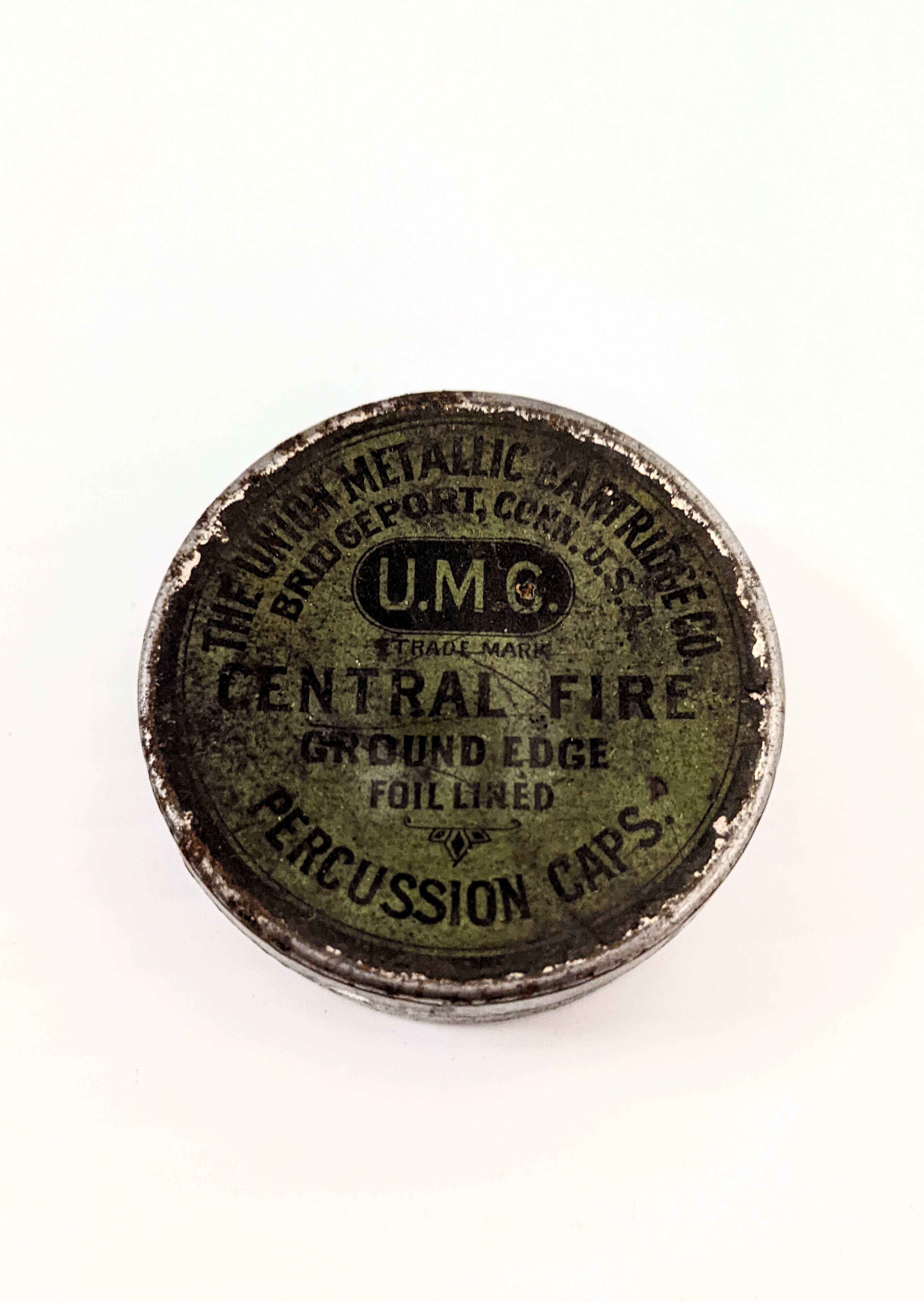This small metal tin is a container for Blasting Caps. Made by the Union Metallic Cartridge Company of Conn. USA these caps were integral to the firing of a rifle. These small caps were integral to the cap lock mechanism of ignition for firearms. They contain a small about of fulminates which explode and create sparks upon impact of a hammer - these sparks would then ignite the main powder charge and fire the cartridge. The hammer of a modern firearm ignites the powder charge of a cartridge directly thus removing a step - and the need for blasting caps!
2007.61.01.22 / Tourangeau, Martha & Harvey
18/07/2022