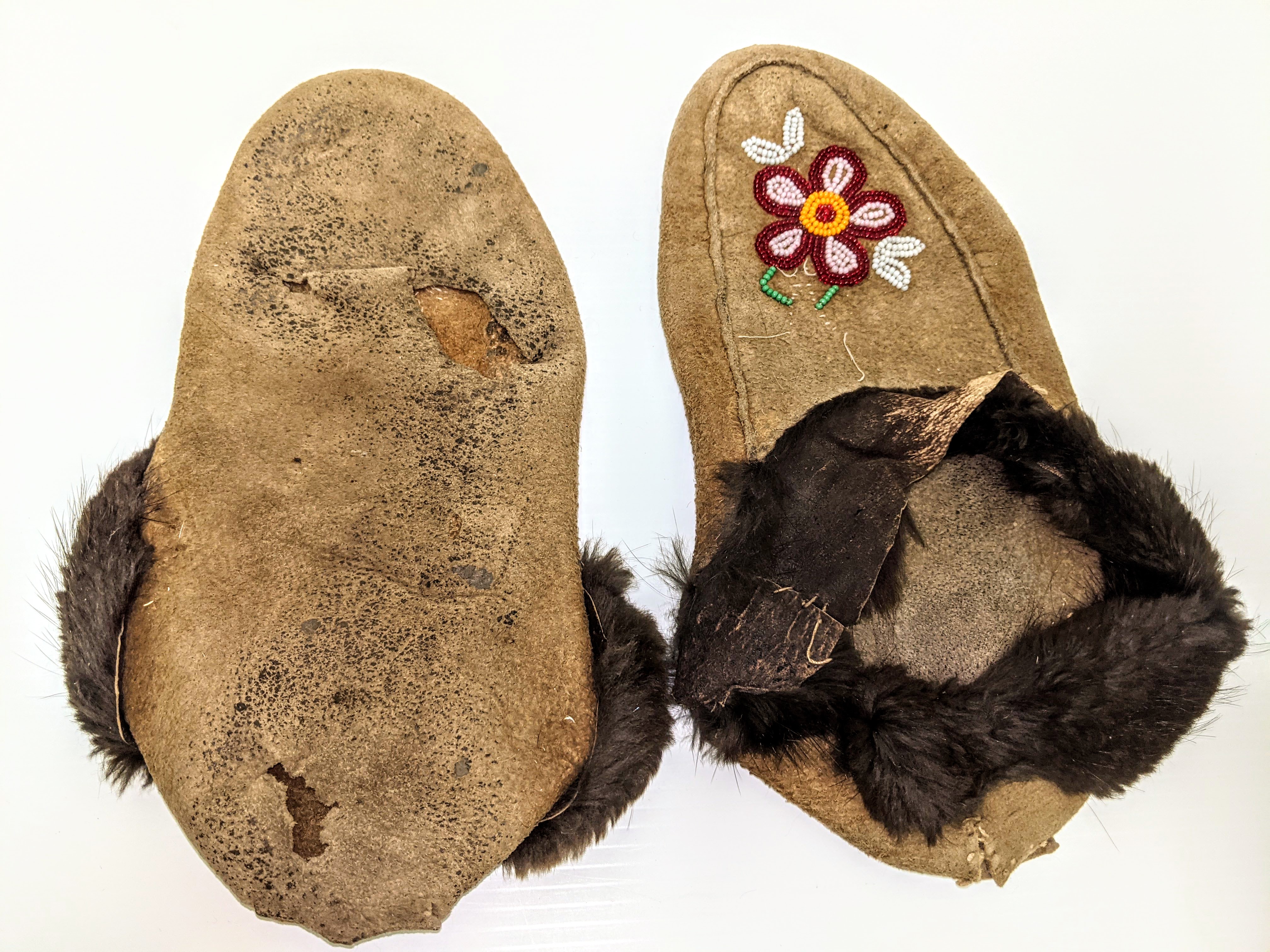 These well worn moccasins once belonged to Verne McRoberts - a notable trapper local to Fort Vermilion. These ones are hand made with traditionally tanned moose hide, trimmed with beaver fur and adorned with glass beads. They have seen many miles (and probably dance floors) as indicated by their worn nature. Moccasins (especially handmade ones) are a prized possession among many locals.
2017.01.01 / McRoberts, Verne