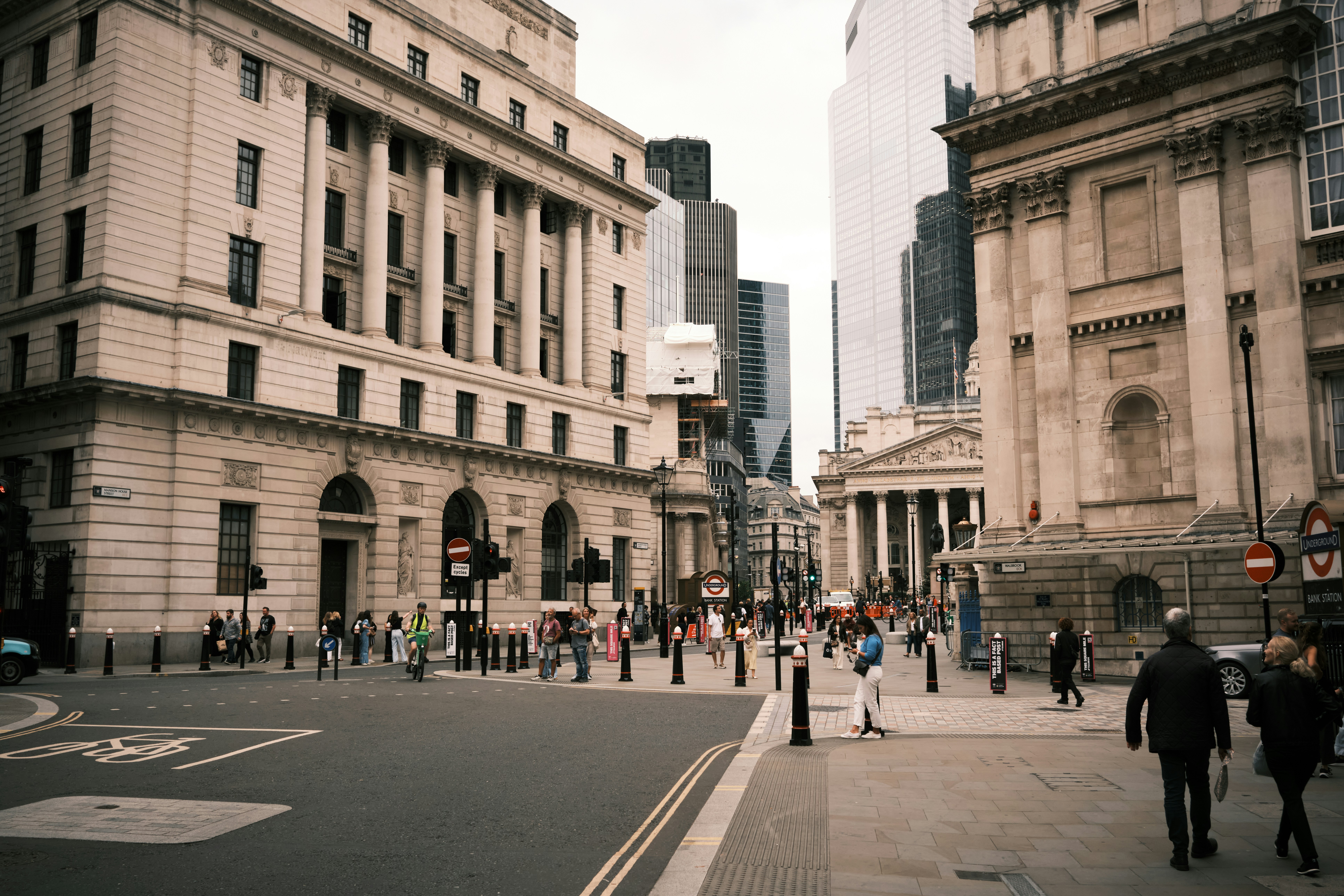Pedestrians walking near Bank Station in the financial district of London