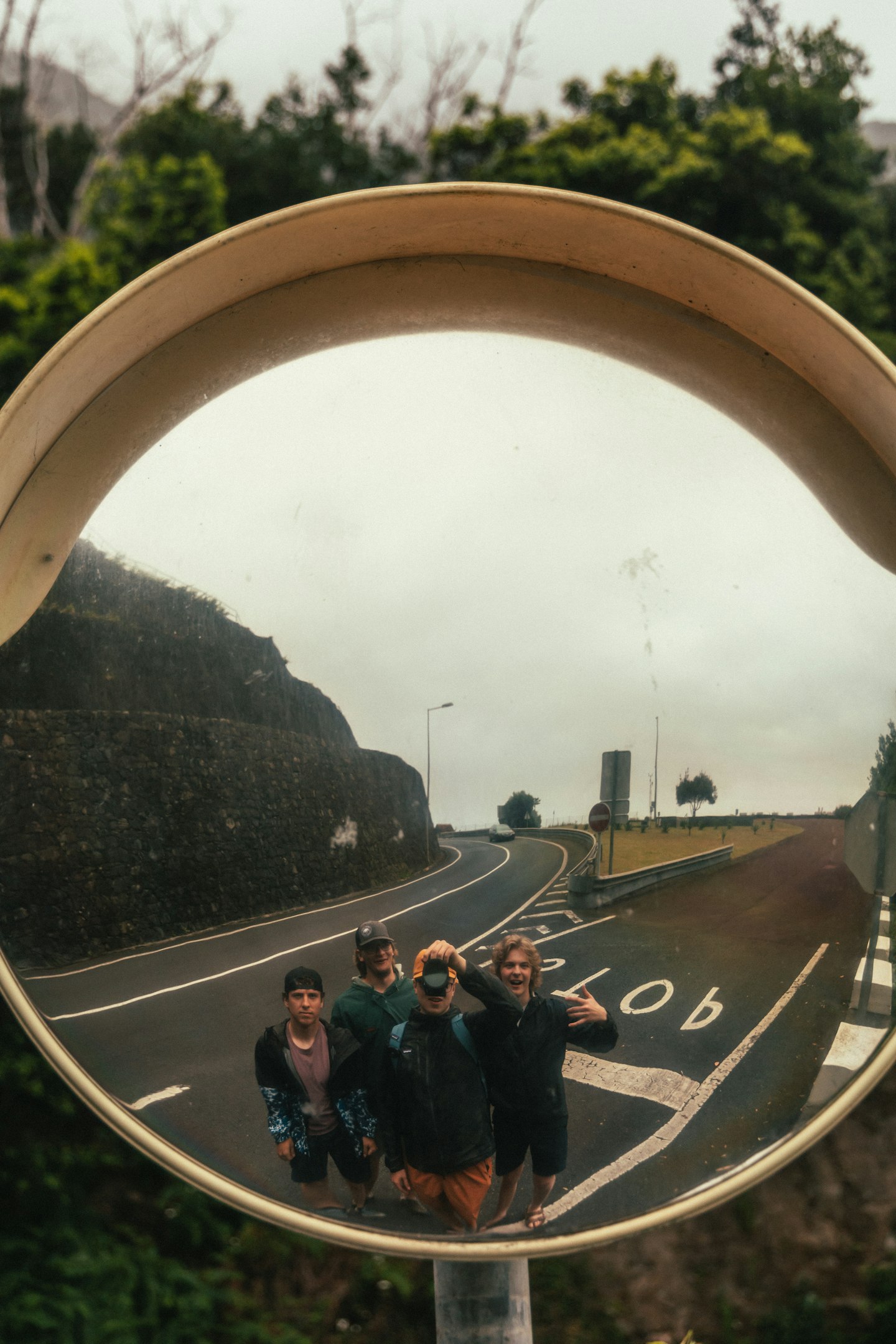 a group of people standing in front of a mirror