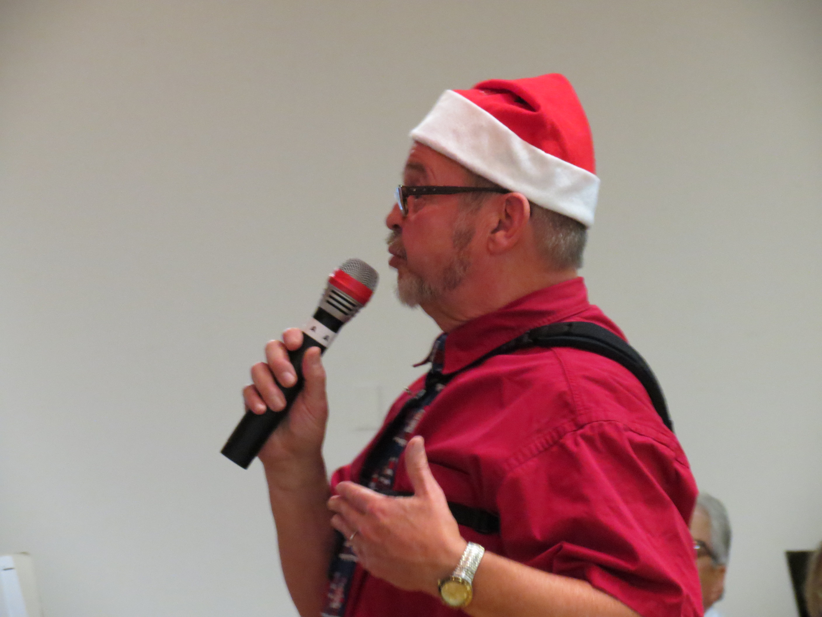 Band Member in Christmas costume speaking to audience Christmas 2017