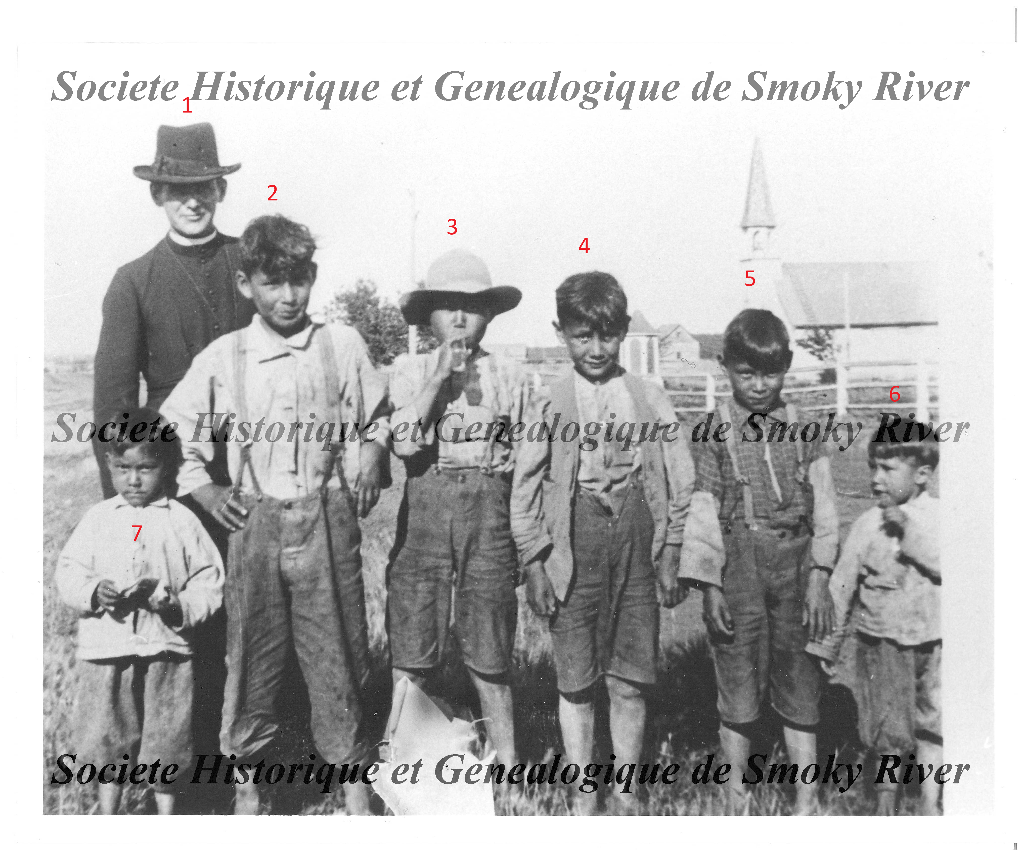This is a photo of Father Quemeneur (#1) with unknown children. Father Quemeneur was in Fort Vermilion from 1926 - 1934 & again from 1942 - 1949 - we don't have a date for when this photo was taken. In the background you can see the Catholic church and the small lattice enclosed shrine. Let us know if you recognize these faces!
2006.01.54 / Societe Historique et Genealogique de Smoky River