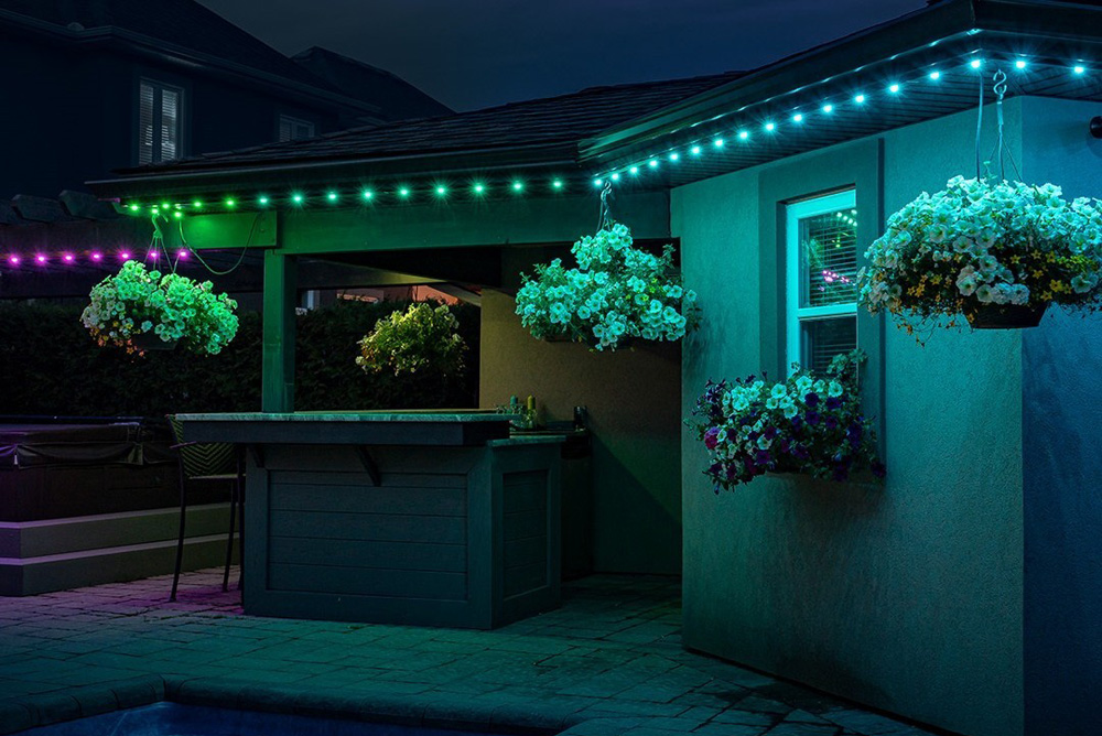 House lit with soft purples, teals, and blues in the evening.
