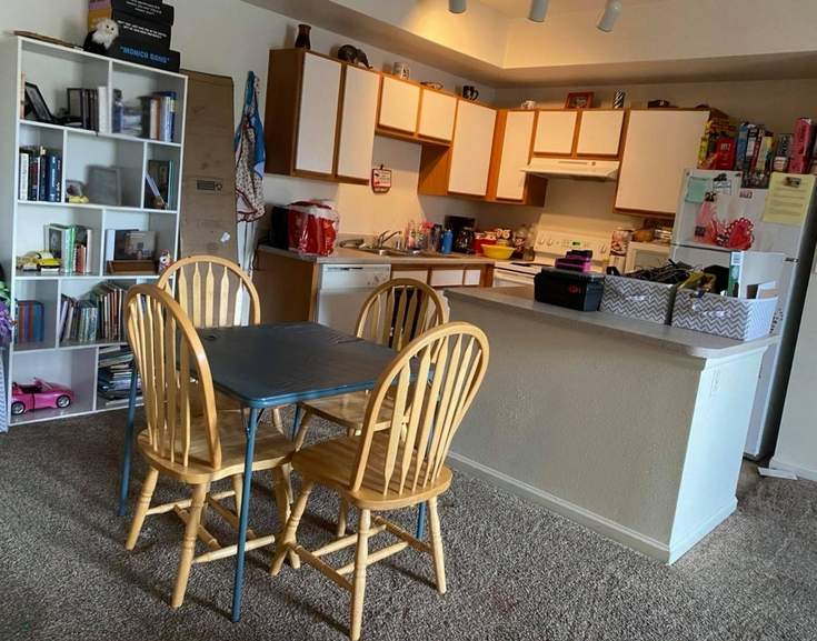 Living and kitchen area restored following neglected property recovery with clutter reduced and the environment returned to improved functional condition