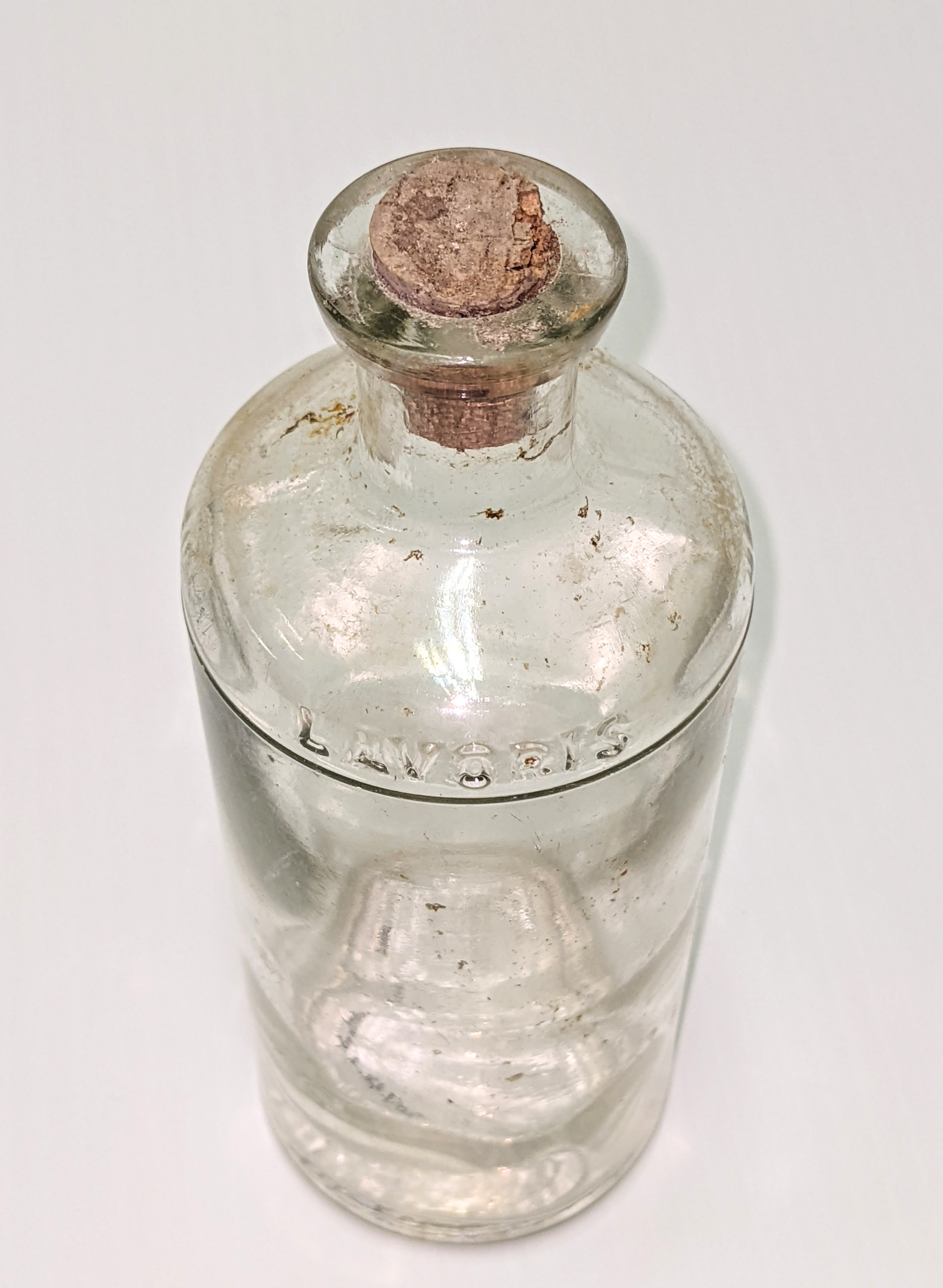 This bottle is from the "Lavoris Chemical Company" as indicated by the glass imprint on the front shoulder of the bottle. Lavoris was a popular mouth wash started in Minneapolis USA and spread widely across North America. This bottle is missing it's label but the bottom indicated that it was made in Toronto Canada and so could be from the 1920's. The mouth wash was mint flavored and contained 3% alcohol.
07/02/2022
2007.48.02.04 / Friends of the Old Bay House Society
