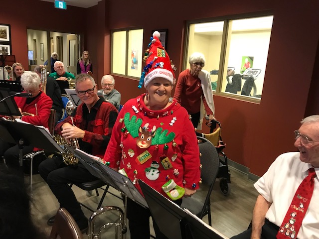 Band member dressed in a red reindeer shirt and red elf hat for Christmas 2019