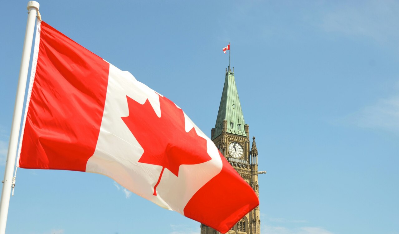 A Canadian flag waving before the Peace Tower on Parliament Hill in Ottawa A Canadian flag waving before the Peace Tower on Parliament Hill in Ottawa