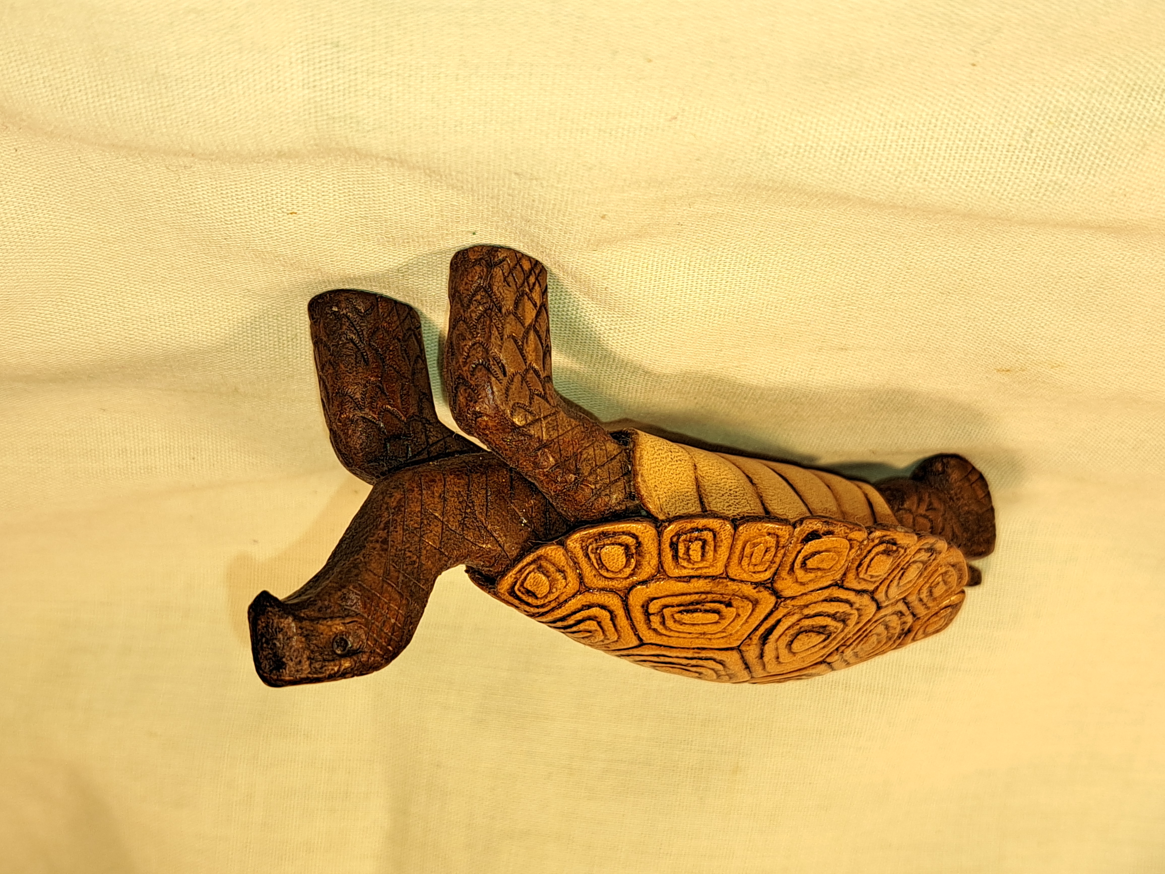 Leather artwork shaped like a turtle
