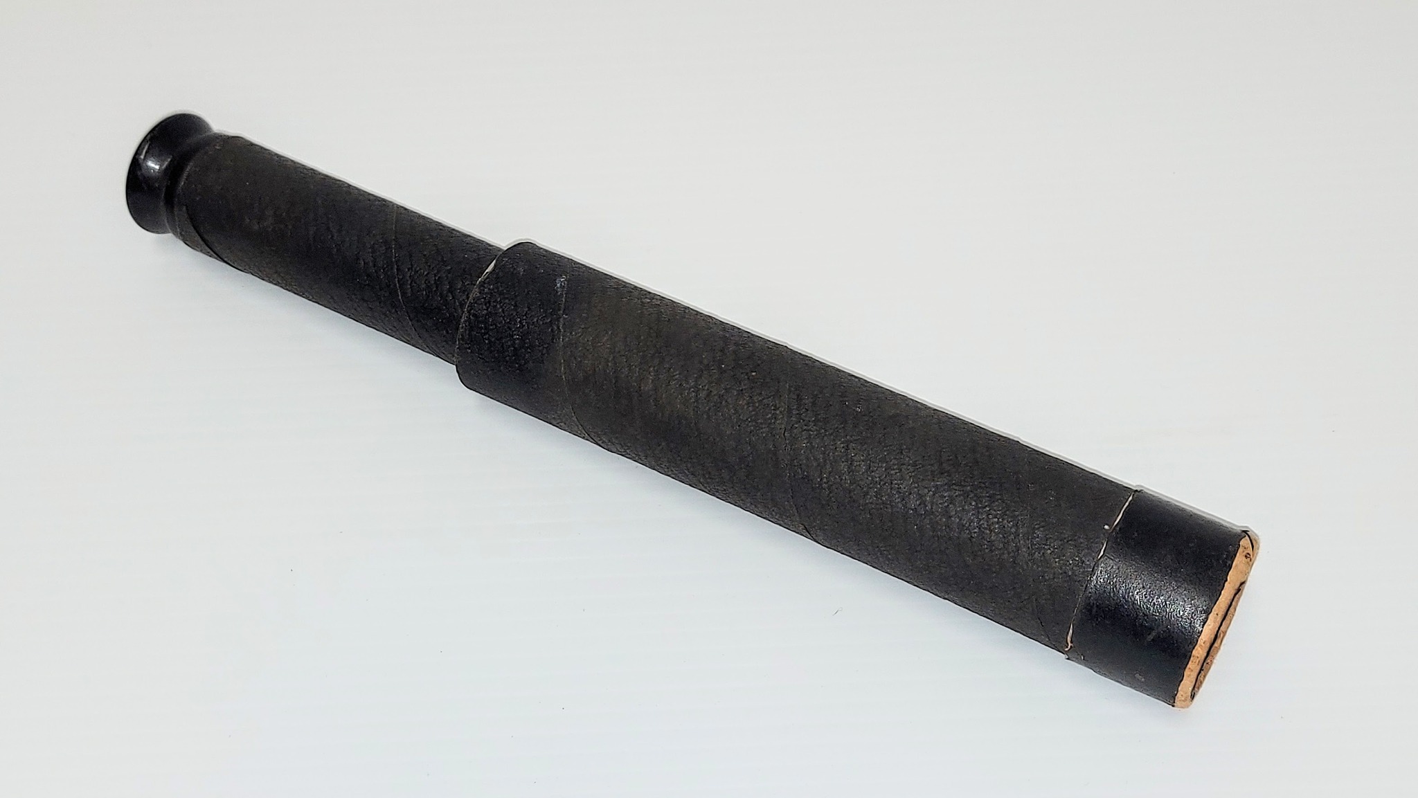 This is a cardboard toy spyglass. It is not branded nor have labels of any sort - but does work and provides about 4X magnification! The lenses are glass and the eyepiece is wooden but all other elements are cardboard. Though our research into it has proven futile we estimate it to be a toy from the 1940's.
2002.162.02 / Campbell, Jean