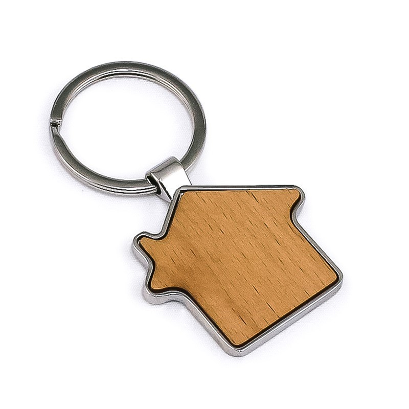 Person in a kitchen setting wearing a blue and white shirt with a graphic, surrounded by various kitchen items and two shirts on display.