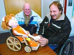 Mr. Ford Young SHowing the President of Handy Circle Resource Society the wheelchair he made for Destiny our mascot Mr. Ford Young SHowing the President of Handy Circle Resource Society the wheelchair he made for Destiny our mascot