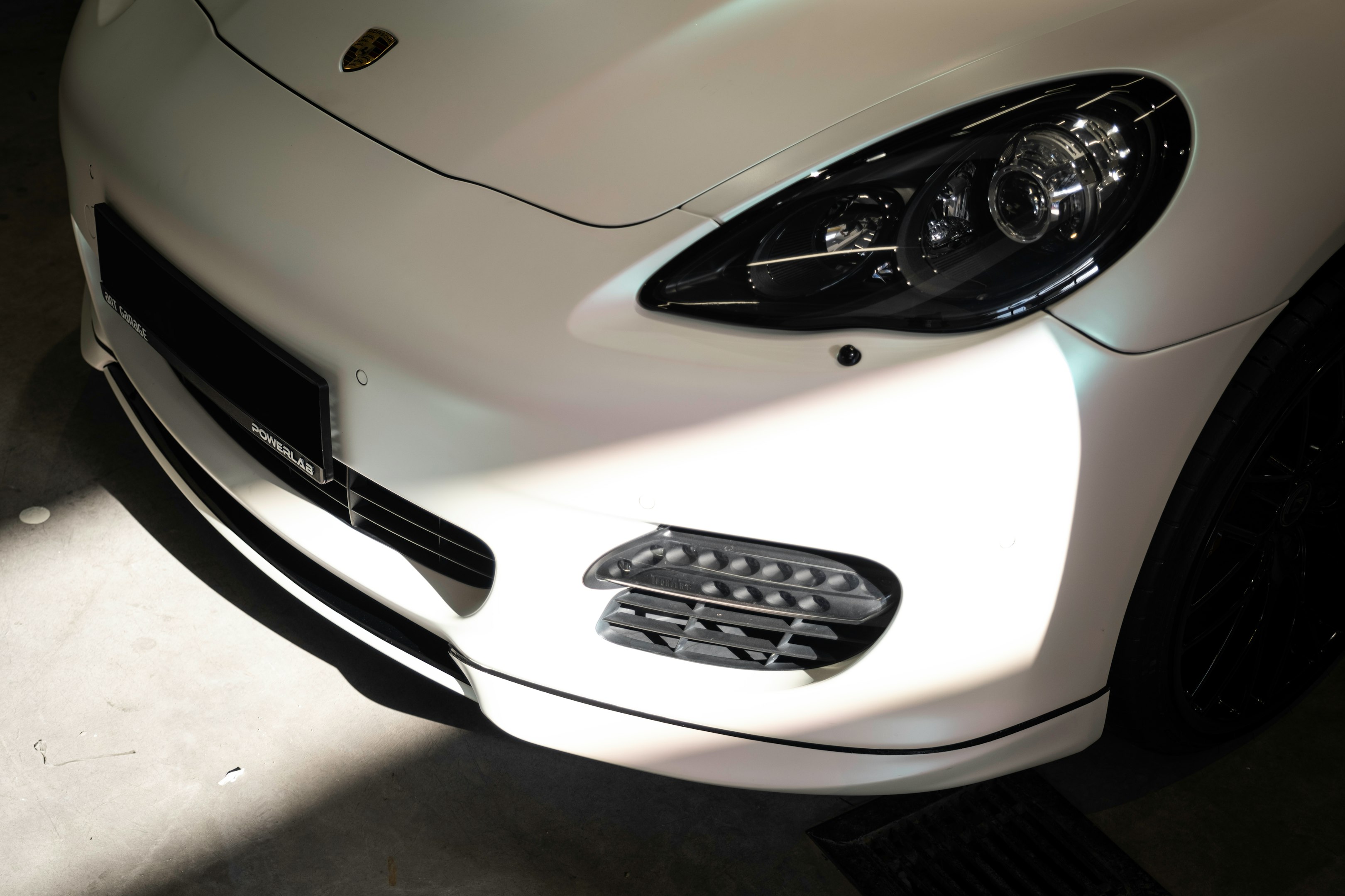 a white sports car parked in a garage