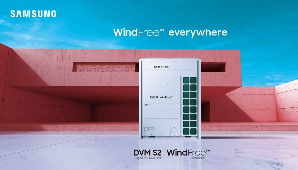 Modern living room with an air conditioning unit, featuring a cozy chair, green plants, and wooden flooring.