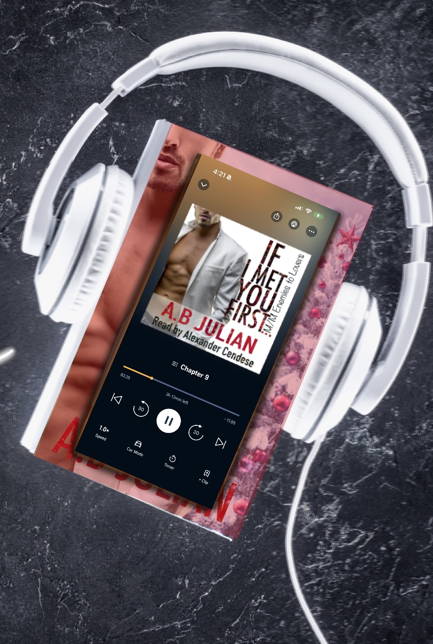 Young man reading a book at a wooden table surrounded by potted plants and bookshelves.
