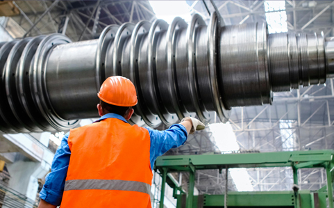 A man in an orange vest and hardhat, working