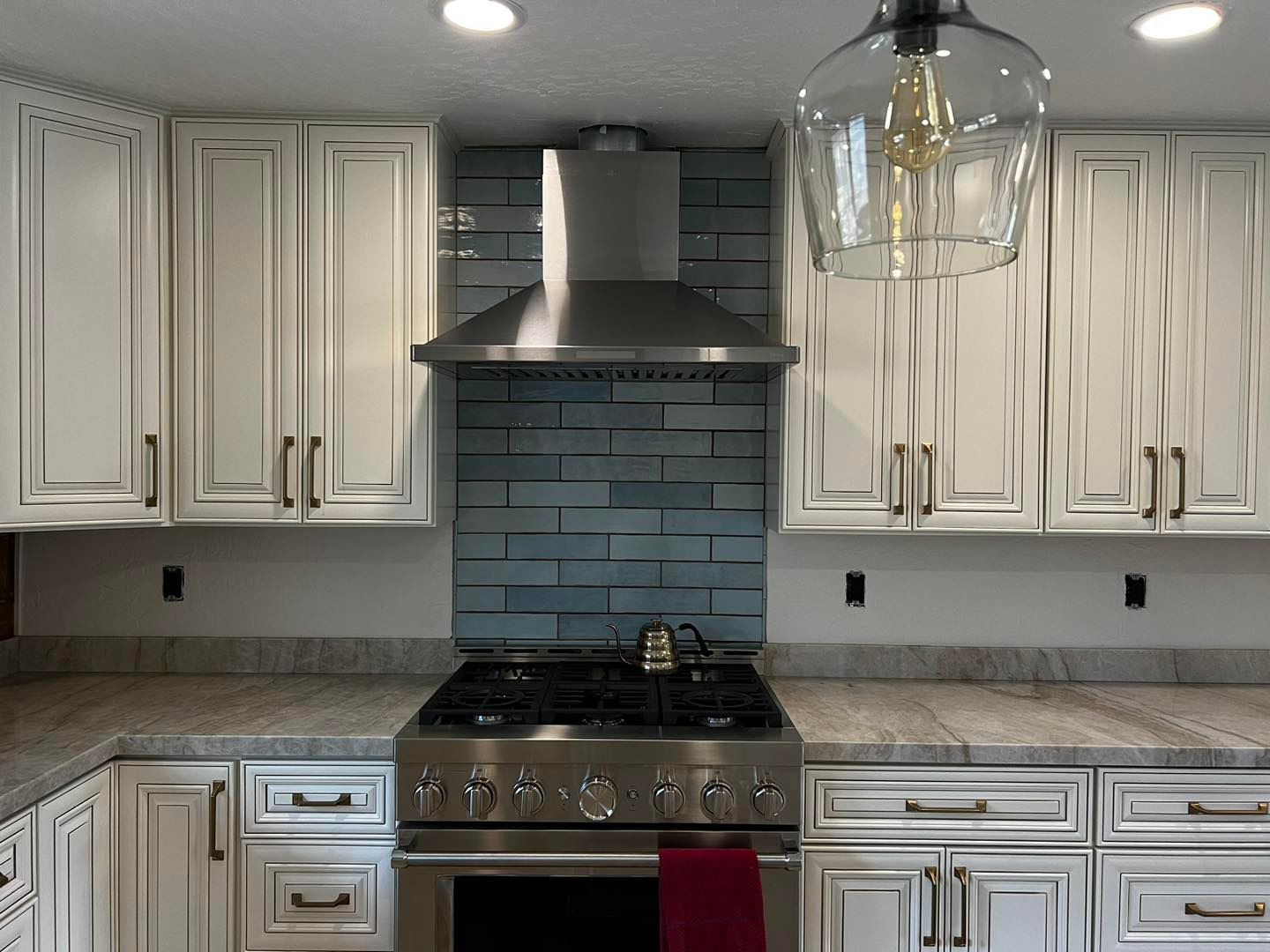 Modern Kitchen with Stainless Steel Range and Blue Tile Backsplash