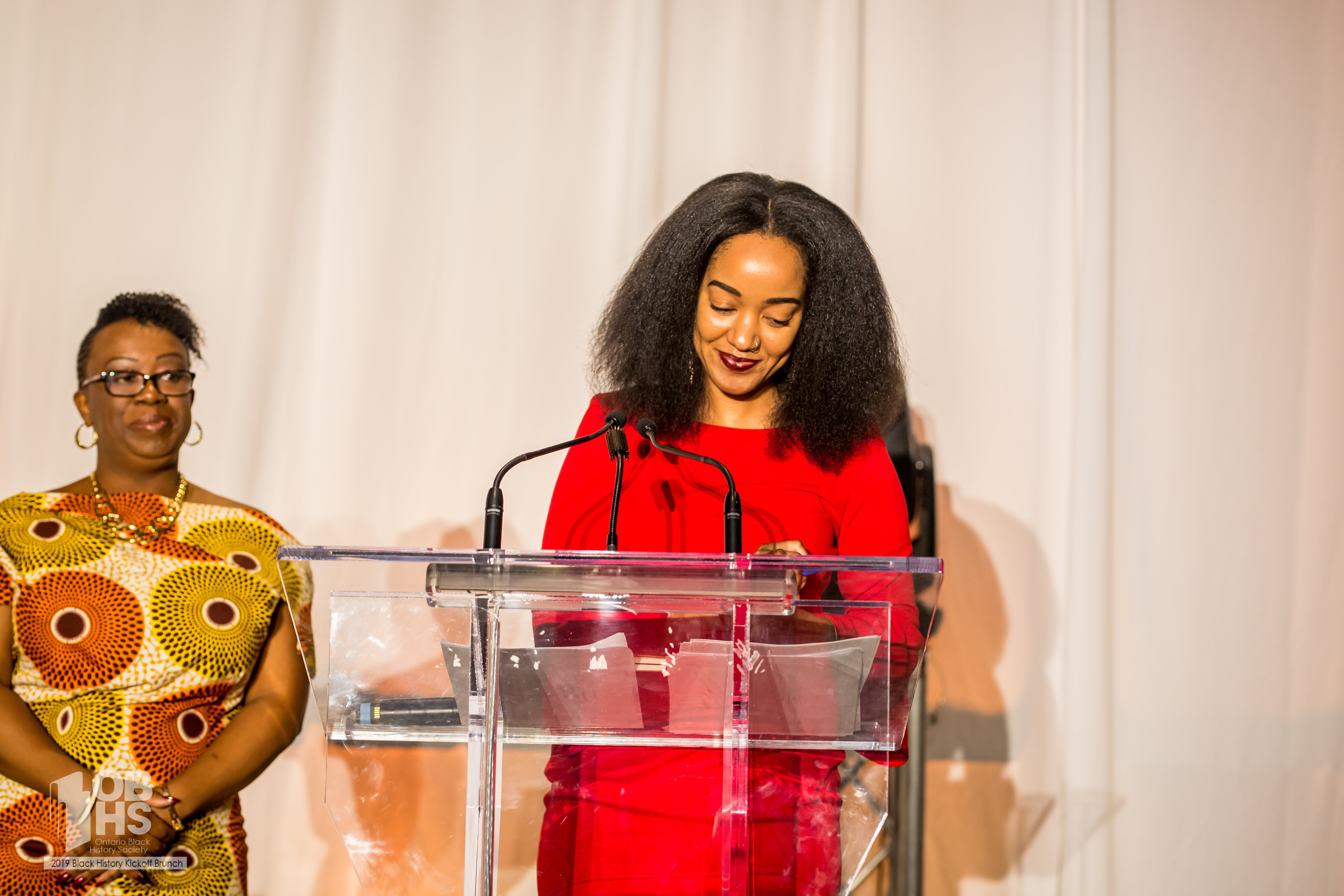 Host Amanda Parris and OBHS President Natasha Henry share a proud moment with the audience - photo by www.sayhilondon.com