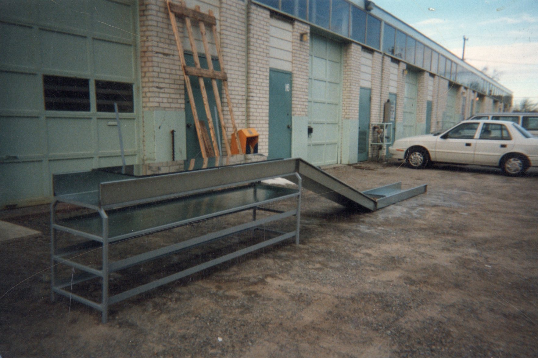 Close-up of industrial pressure gauges and valves in black and white.