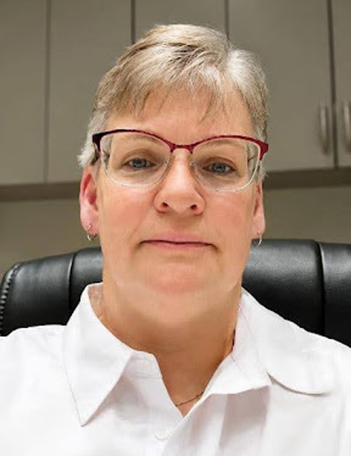 Rebecca wearing a white shirt and glasses