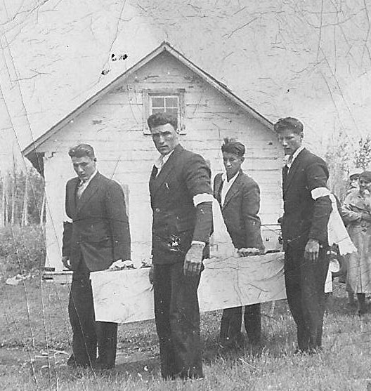 This picture is taken during unfortunate circumstances, as what appears to be four brothers, carry a coffin to the St Louis church gravesite in Buttertown. It is unknown whos funeral this procession is for nor who the pallbearers are - if you have any insight please let us know!



----EDIT----

We have been able to identify the gentleman on the left as Mac Lambert the man in front as John James Lambert and the fellow third from left as Charlie Lambert. 

2005.24.14 / Schartner, Bob
