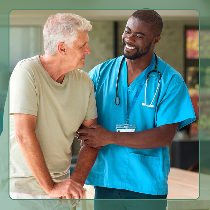 A male nurse assisting an elderly man